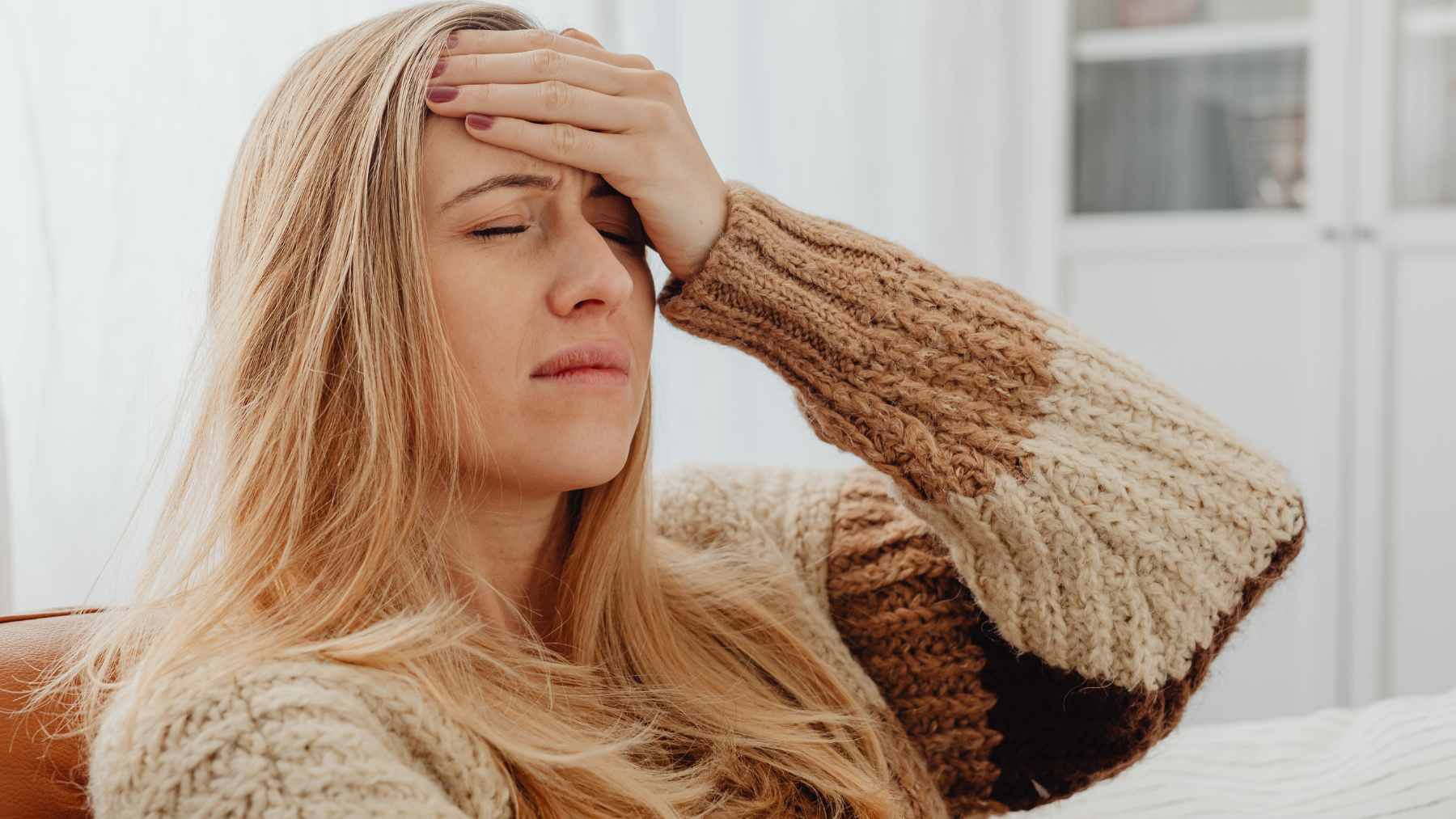 A person waking up in the morning feeling thirsty, representing potential early warning signs of high blood sugar or diabetes.
