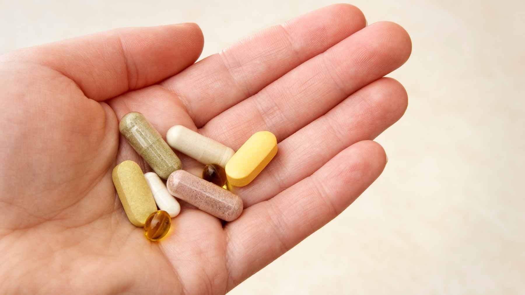A selection of supplement bottles including omega-3, magnesium, and collagen displayed alongside healthy food options.