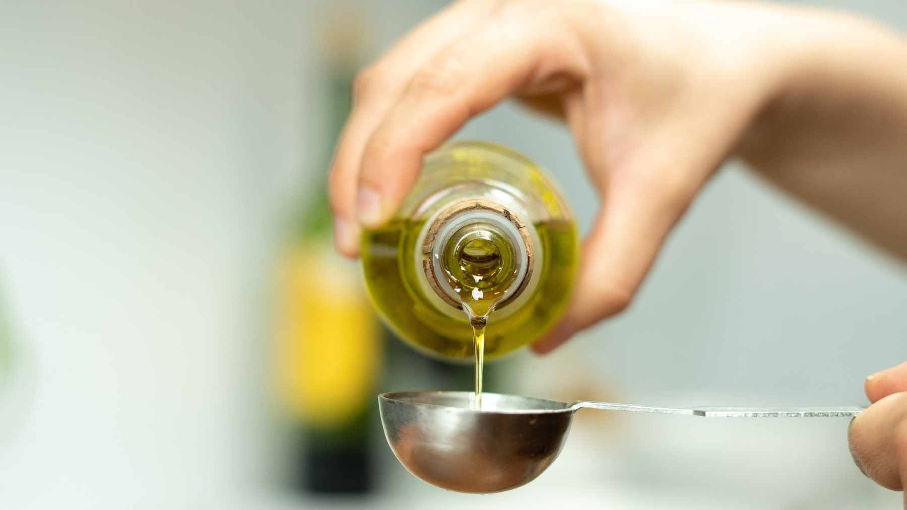 Eat a little less, walk briskly and add one pantry staple: a six-year Spanish study says this trio could help hold off diabetes 1 A bottle of extra virgin olive oil next to fresh vegetables and a measuring tape, illustrating healthy lifestyle choices to prevent diabetes.