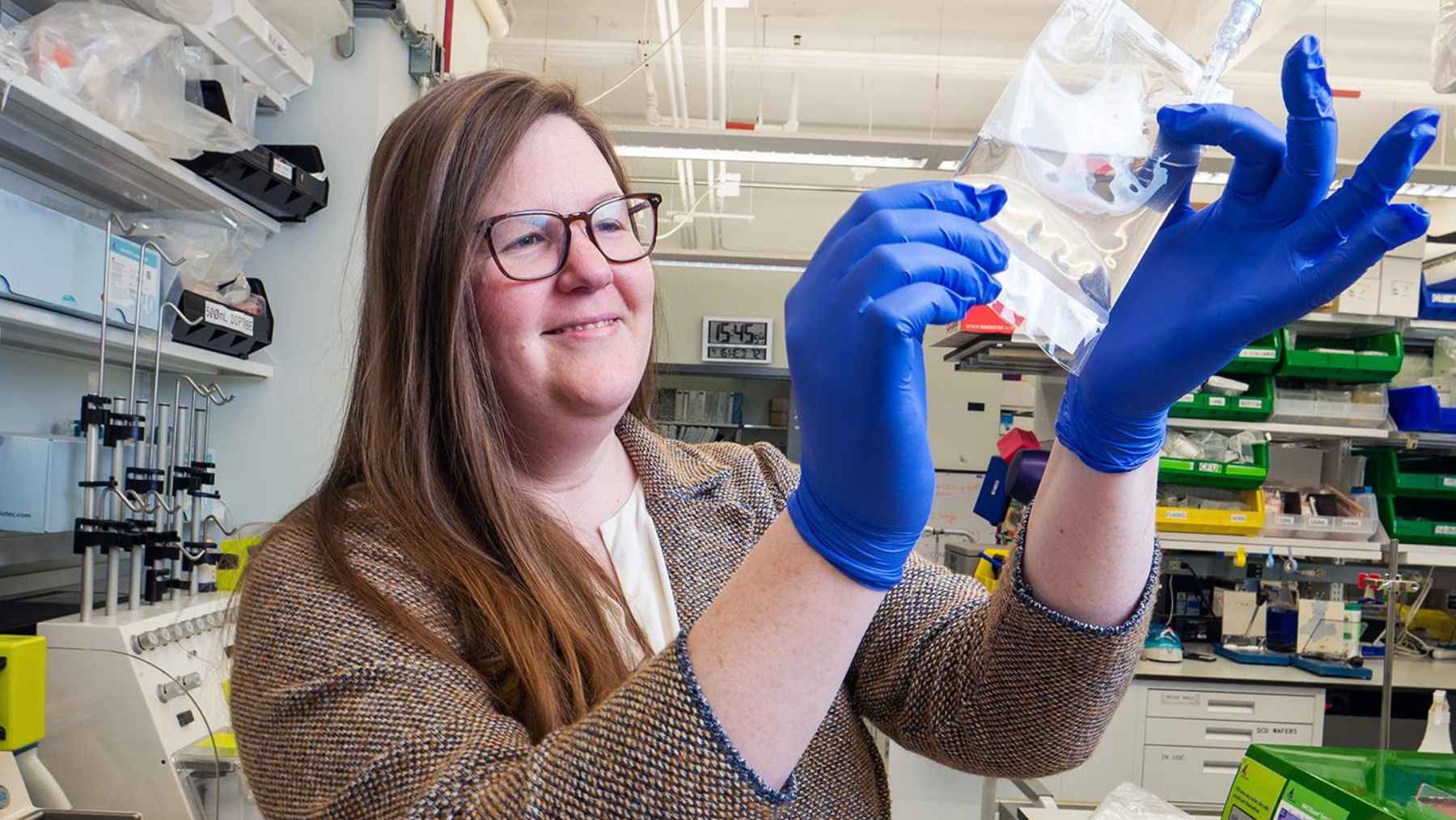 If you think chemo is the only way to beat aggressive cancer, this teen's revolutionary treatment will change your mind 1 Researcher wearing blue gloves examining a laboratory sample during biomedical cell therapy research.