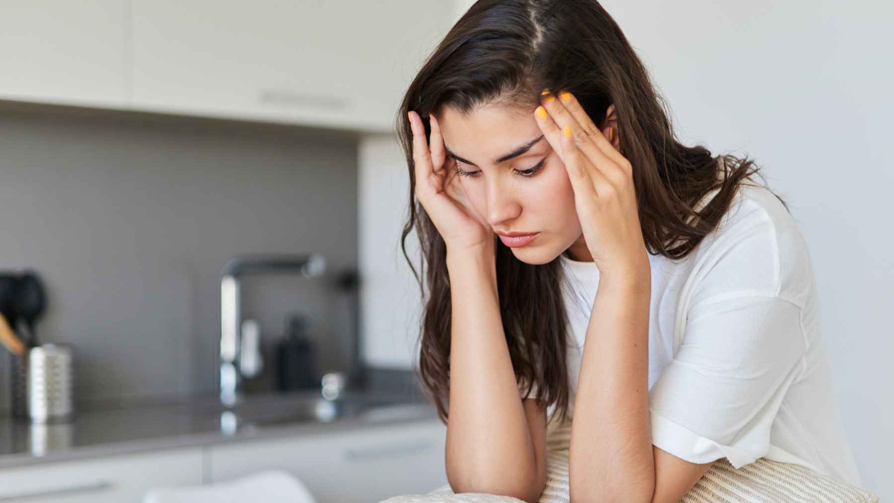 Person experiencing silent anxiety while sitting alone, illustrating the hidden emotional strain often associated with high-functioning anxiety.
