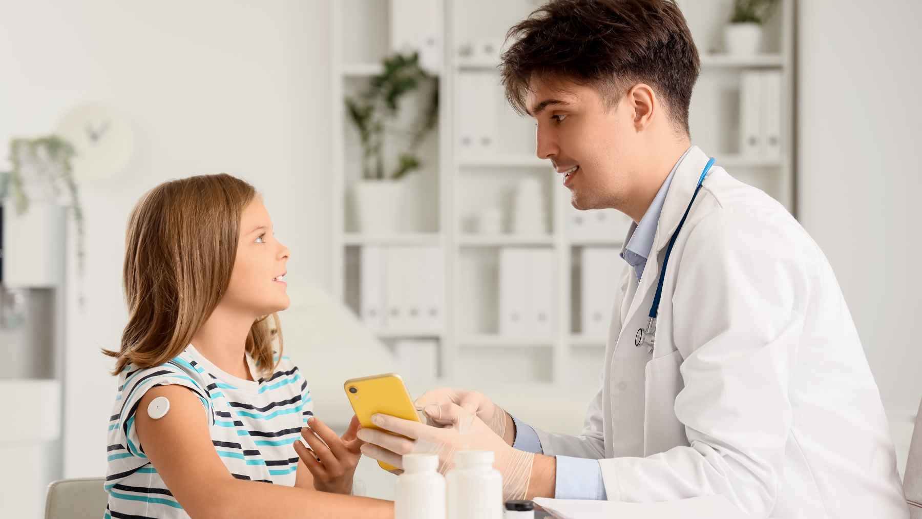 Healthcare professional administering teplizumab infusion to a child with early-stage type 1 diabetes as part of NHS treatment.