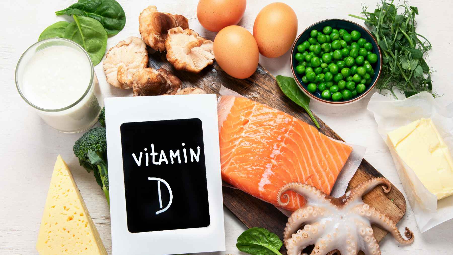 Foods rich in vitamin D and magnesium, including salmon, eggs, milk, spinach, peas, mushrooms, broccoli, and dairy products.