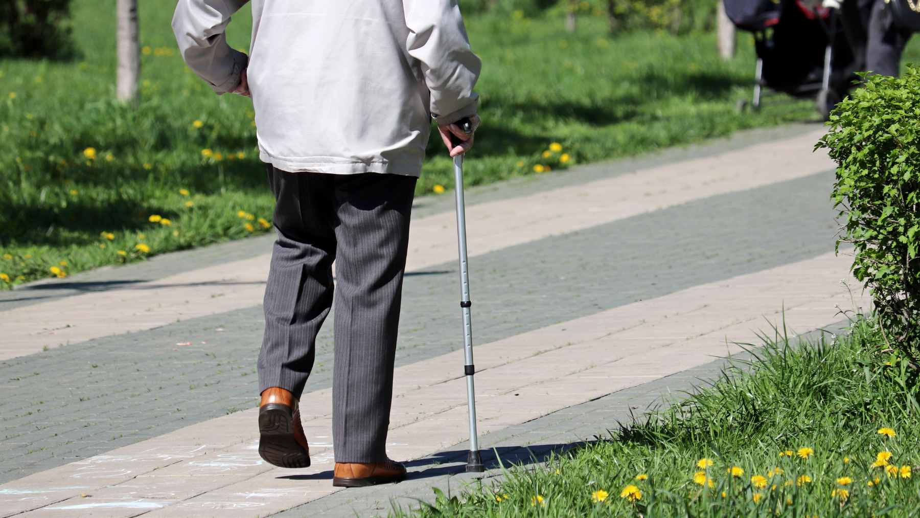 An older adult walking safely inside a climate-controlled indoor space during hot weather conditions.