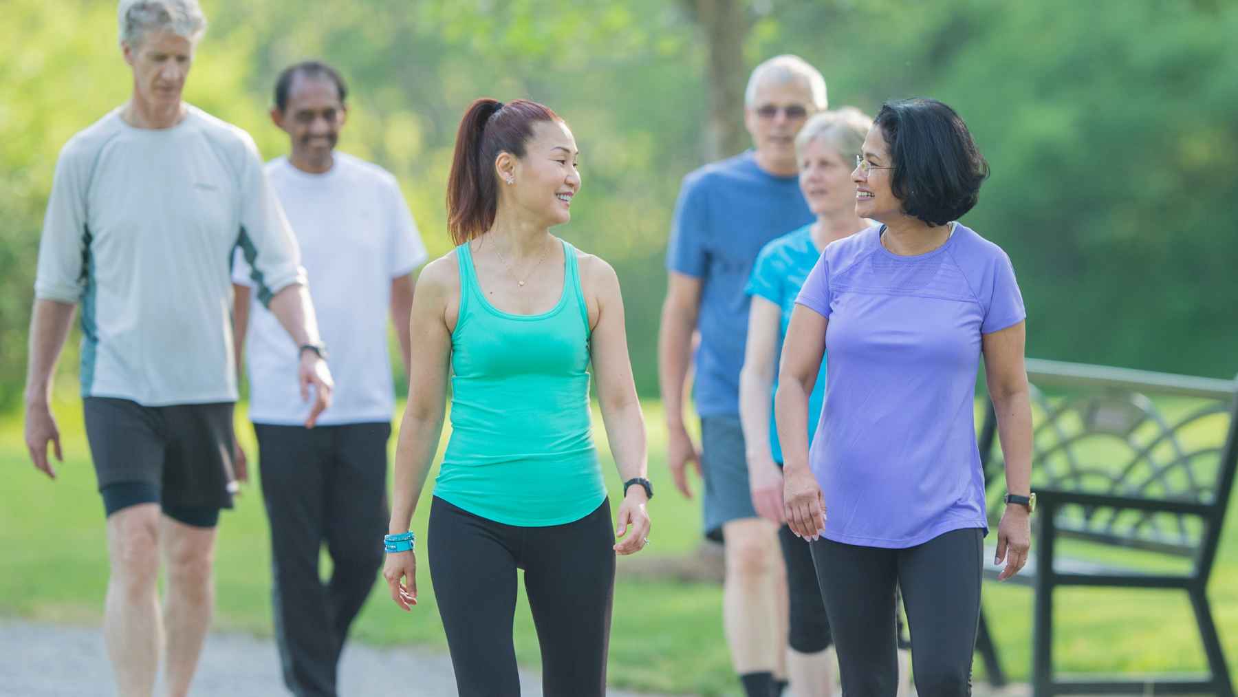 An older adult taking a healthy daily walk in a park, representing exercise benefits for cognitive health.