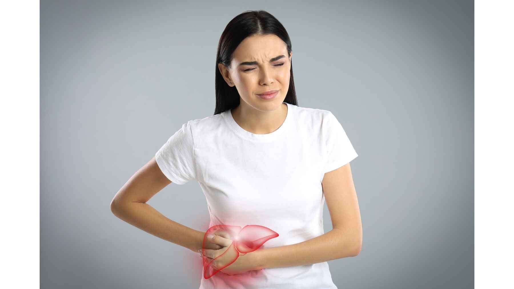 Woman holding her right upper abdomen with a highlighted liver illustration, representing liver pain or fatty liver disease.