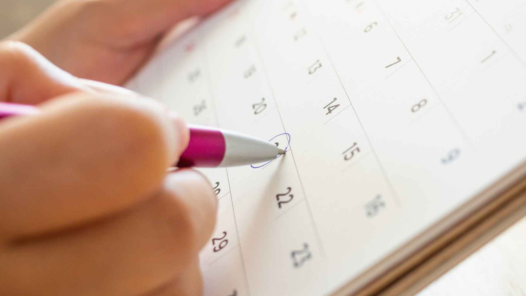 Psychology says people who still write in paper calendars instead of their phone aren't old-fashioned, they value a simplicity most of us have quietly lost 1 Person writing an appointment in a paper calendar with a pen while organizing a monthly schedule by hand.