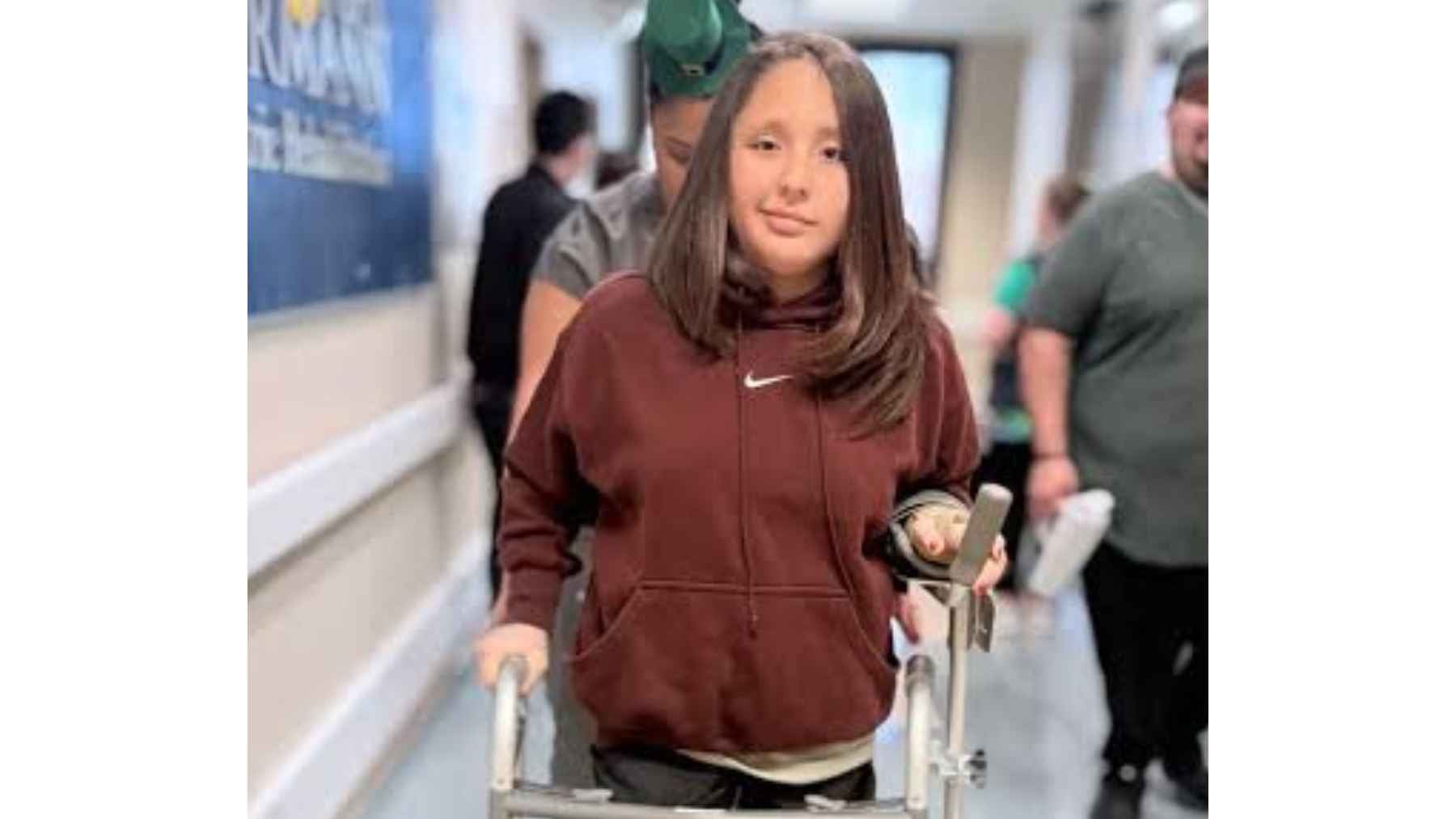 11-year-old stroke survivor walking with a walker during rehabilitation at a Texas hospital
