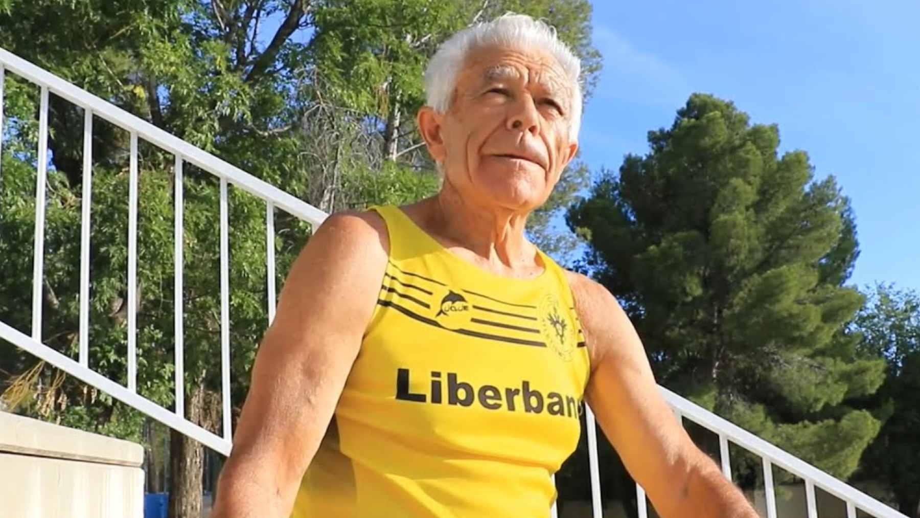 An elderly marathon runner training outdoors, representing lifelong fitness, endurance, and health.