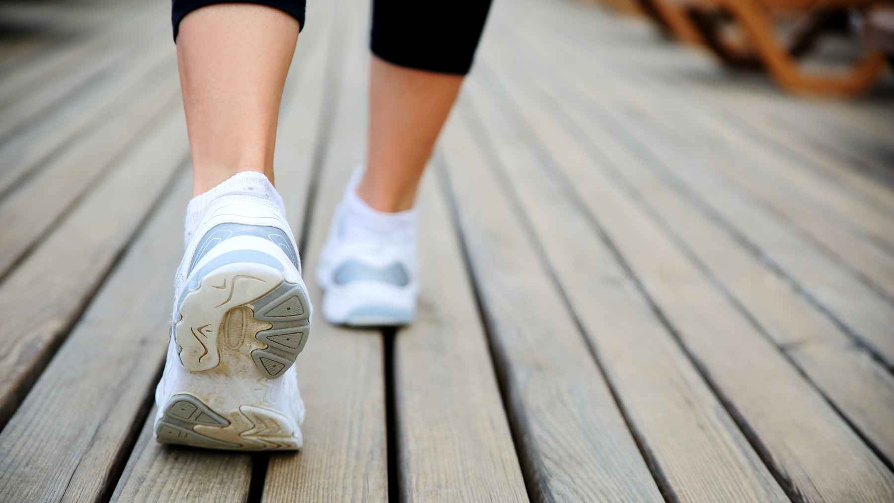 A person walking outdoors for fitness, representing cardiovascular health, daily steps, and physical activity guidelines.