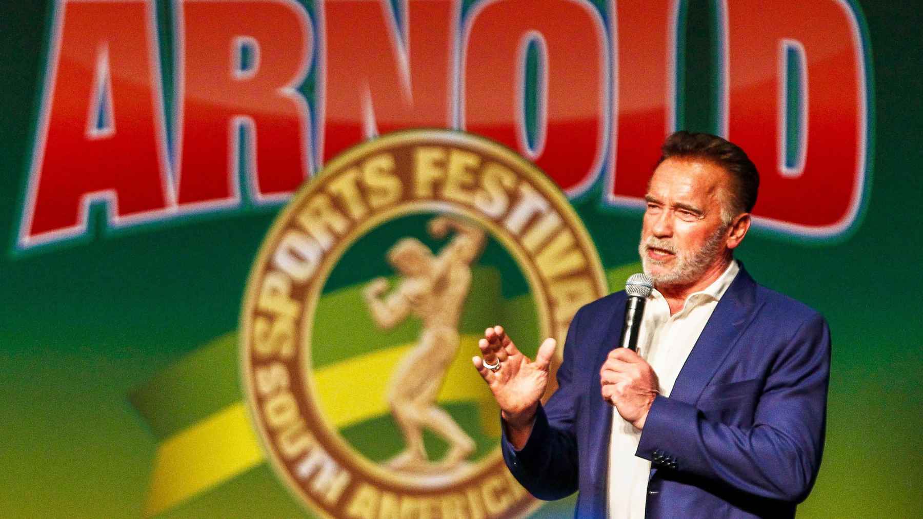 Arnold Schwarzenegger speaking about success, hard work, and taking action during a public appearance.