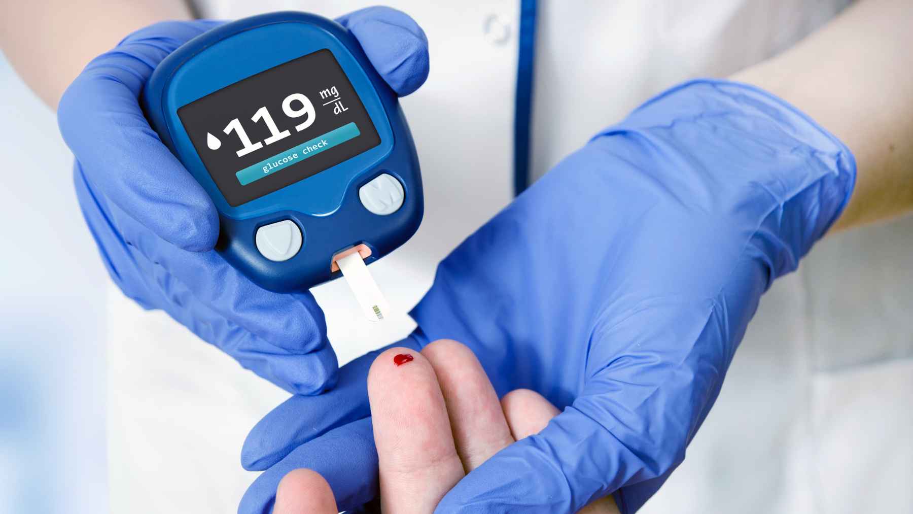 Person checking blood sugar with a glucose meter as part of daily diabetes management after a high glucose reading.