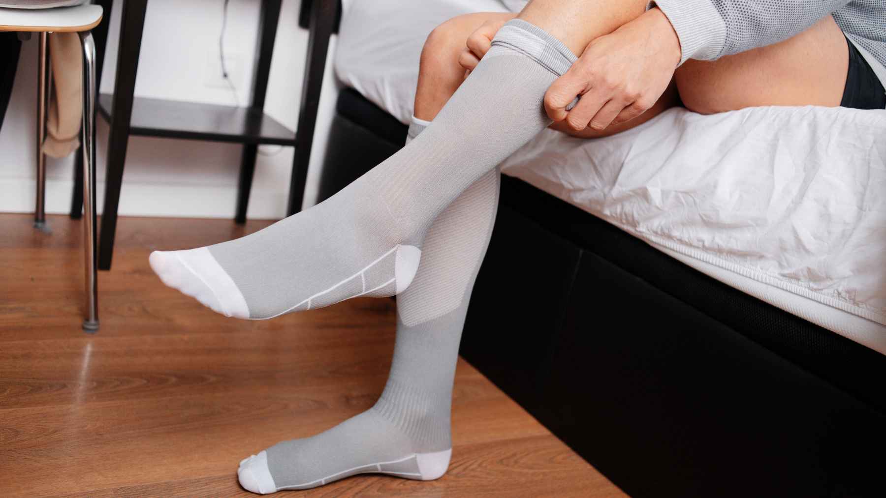 Everyone's trying compression socks for high blood pressure: a top cardiologist reveals what they actually do for your body 1 Colorful compression socks worn by a person on a city street, representing modern wellness trends and leg circulation support.