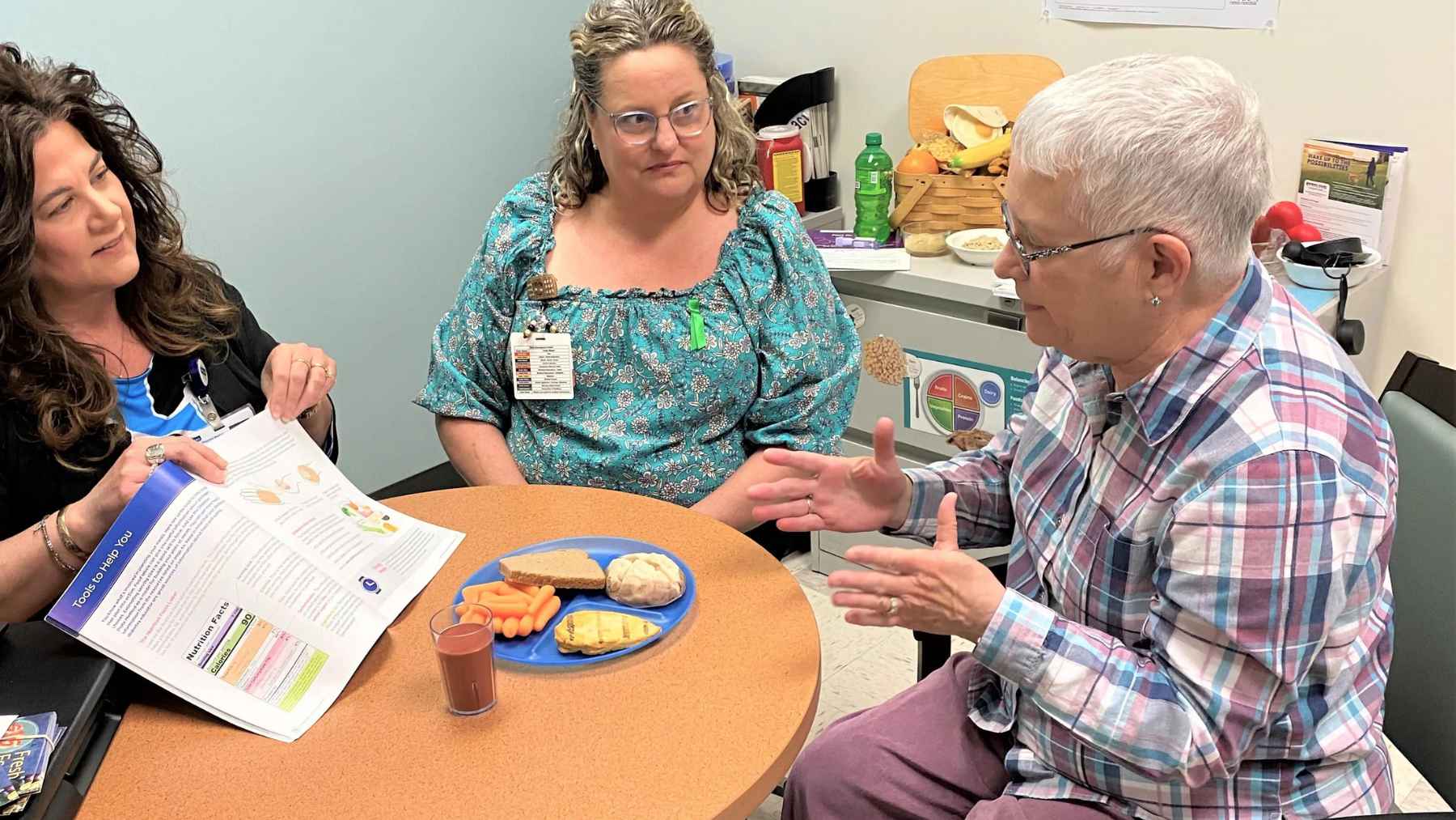A healthcare professional discusses GLP-1 weight-loss medication and nutrition with a patient during a medical consultation.
