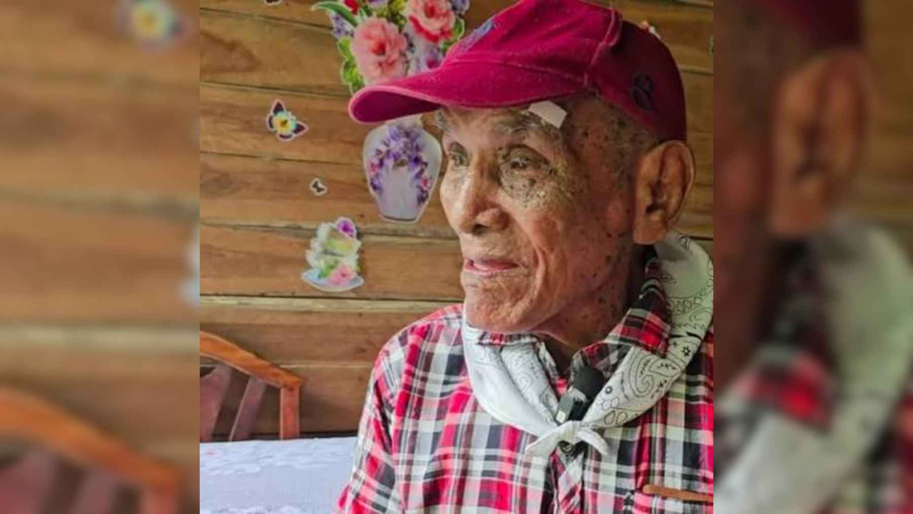 An elderly man sitting comfortably outdoors in a rural Costa Rican community.