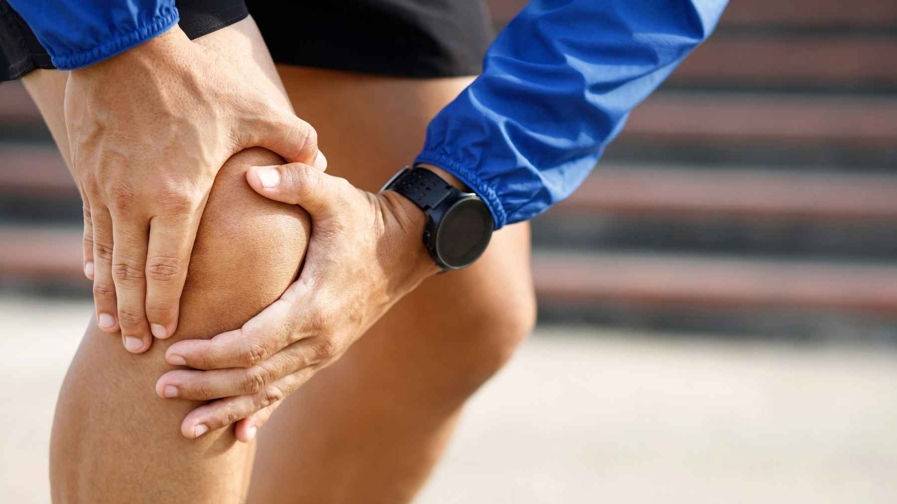 An adult walking outdoors on a park path to maintain knee mobility and joint health.