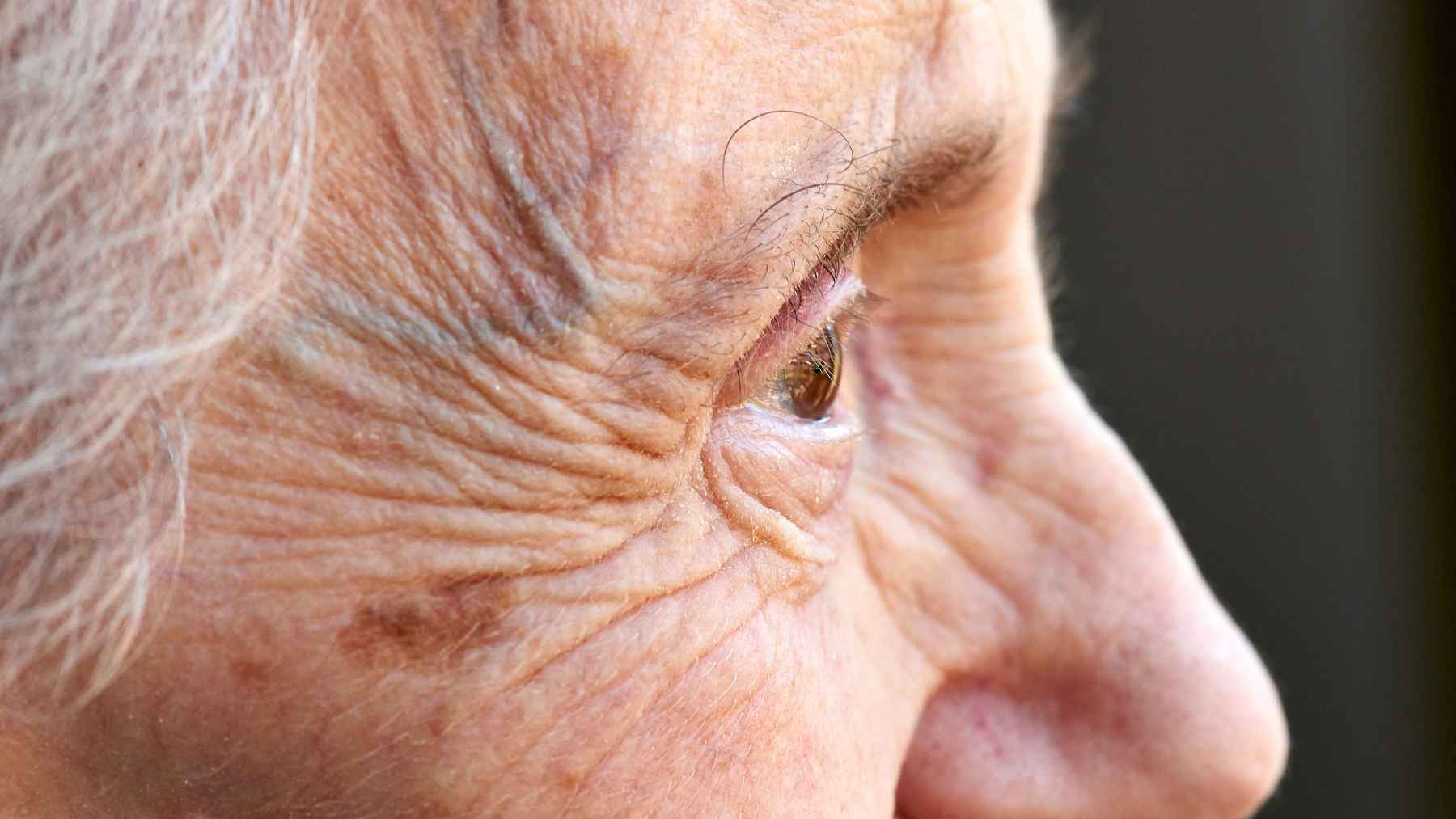 Longevity science says you don't age in a straight line: three sudden drop-offs could explain why some years feel so brutal 2 A person walking up outdoor stairs representing the biological concept of aging and sudden health shifts across different life stages.