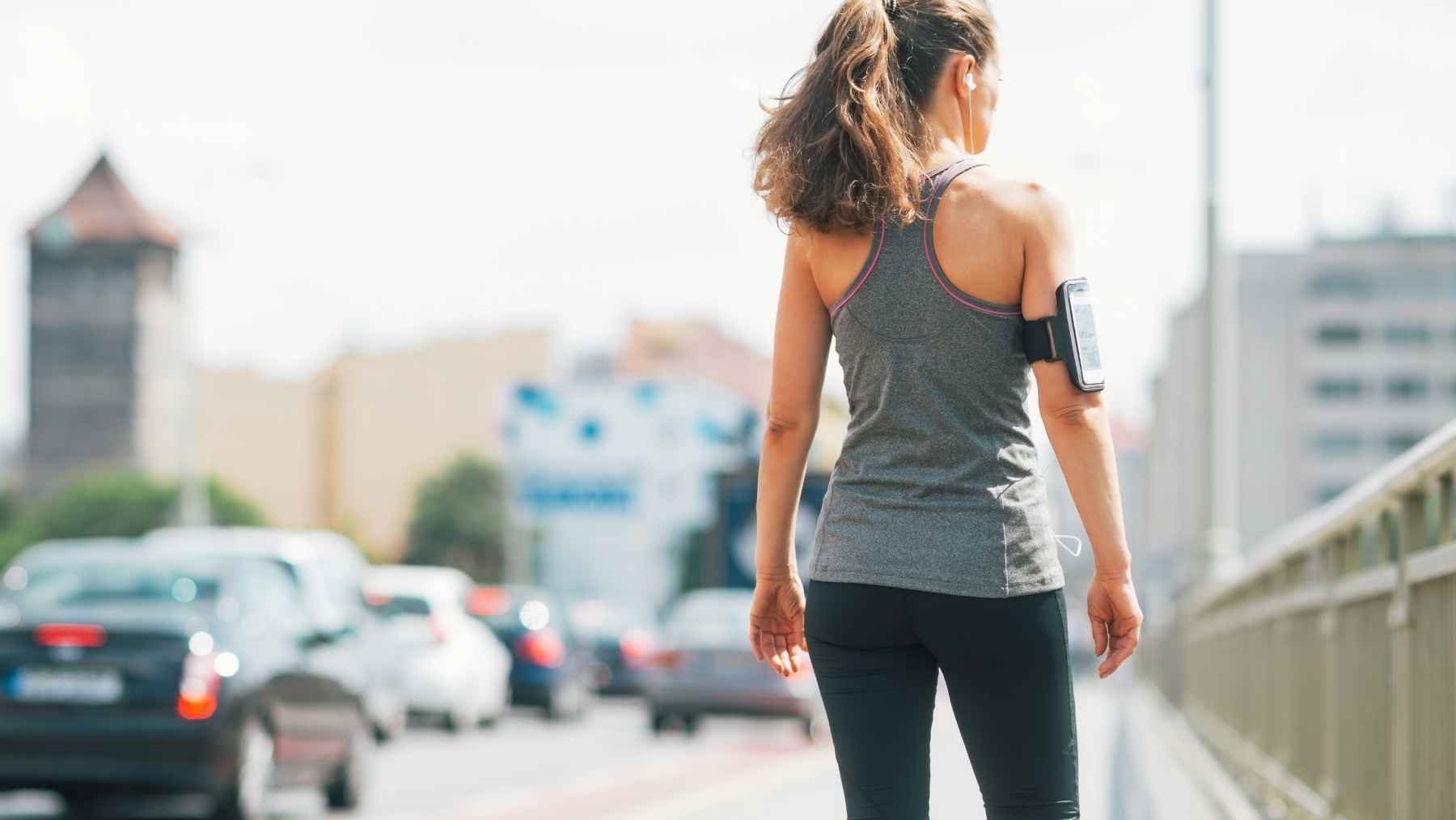Woman practicing lymphatic walking with relaxed posture, arm movement, and controlled breathing.