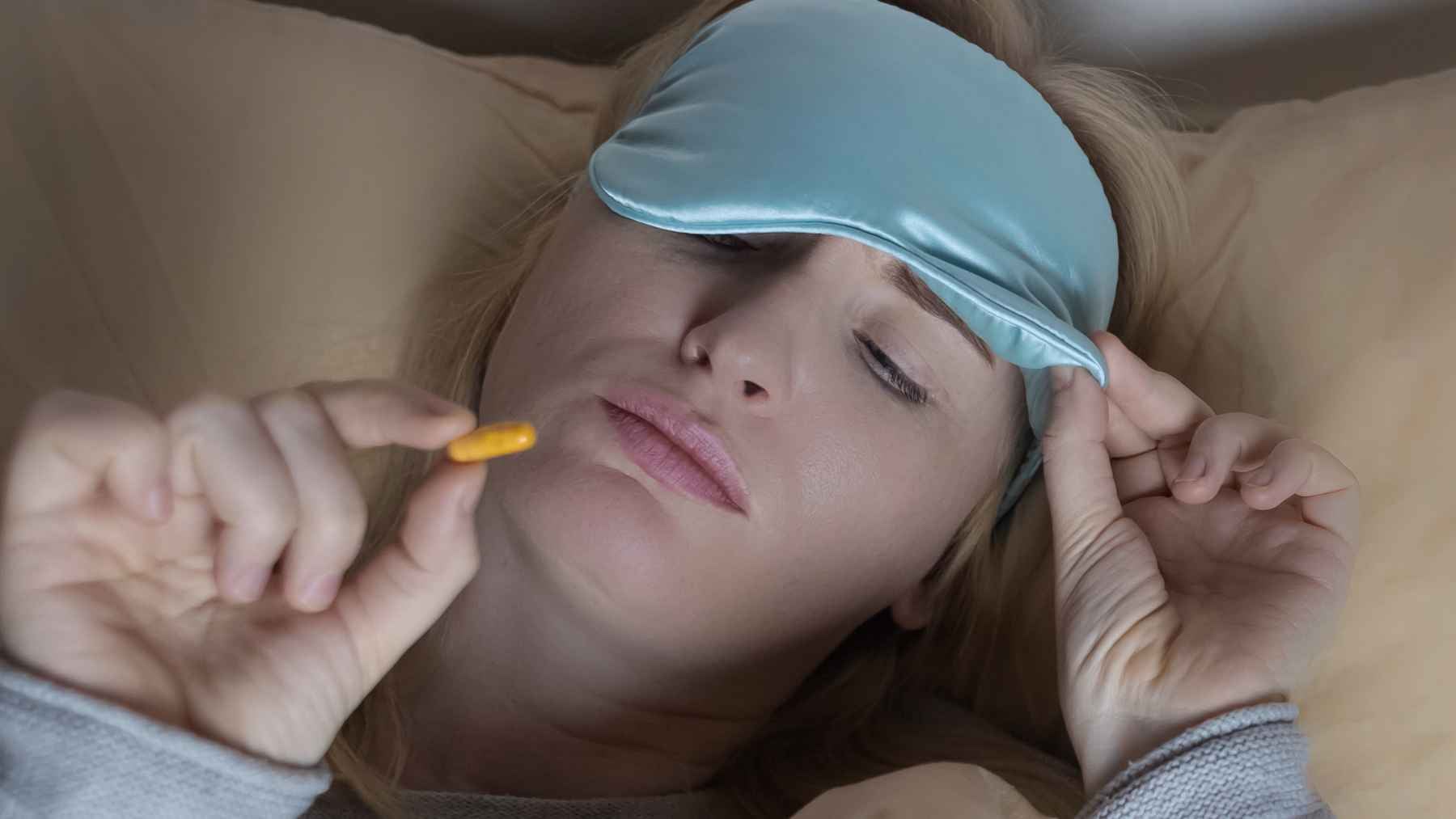 Melatonin supplement tablets beside a glass of water, illustrating research into chronic muscle and joint pain relief beyond sleep.