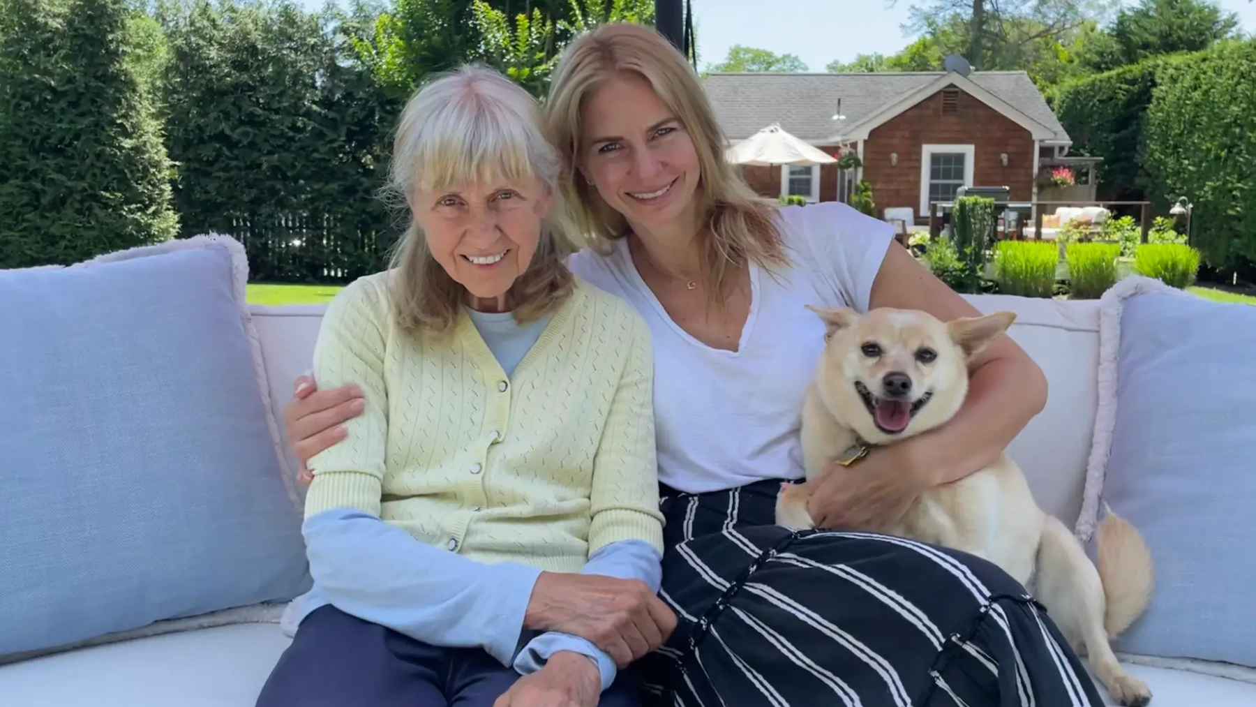 Older mother and adult daughter sitting together outdoors as they plan for aging in place and Alzheimer’s care