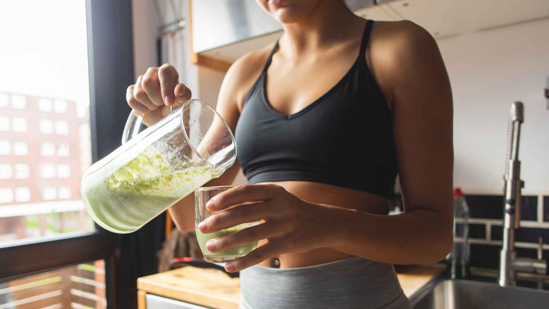 Woman drinking a healthy beverage as part of a routine to support fatty liver health