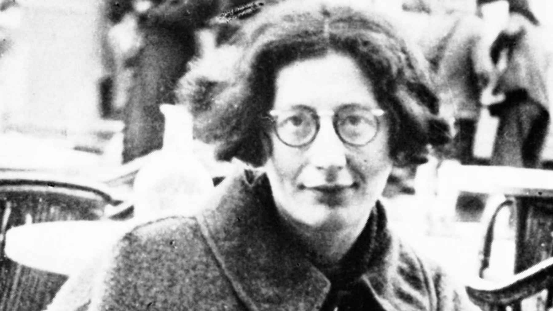 Black-and-white portrait of philosopher Simone Weil wearing glasses and a coat