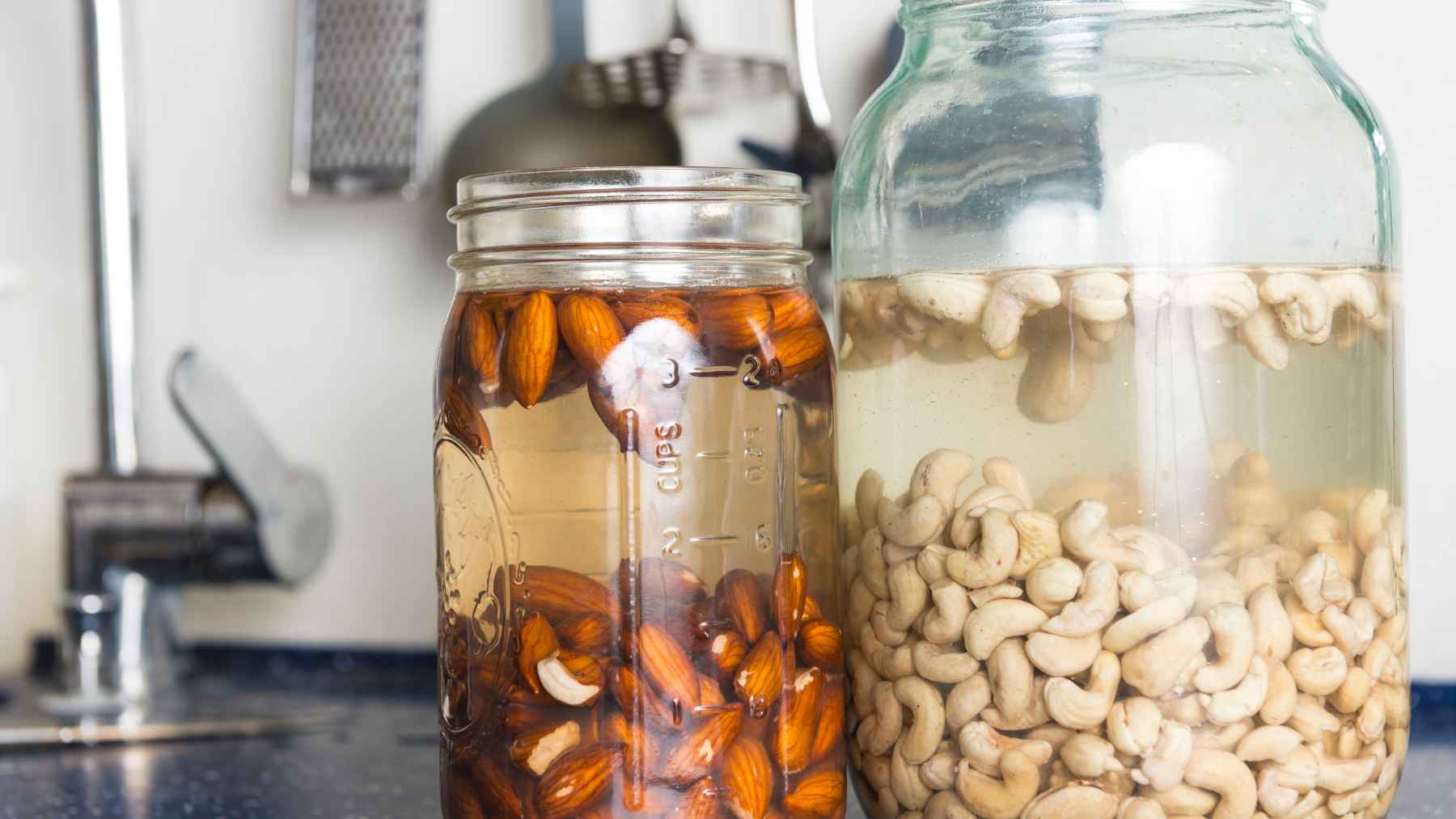 Soaked dates in a bowl of water on a kitchen table, representing morning wellness and dietary fiber.