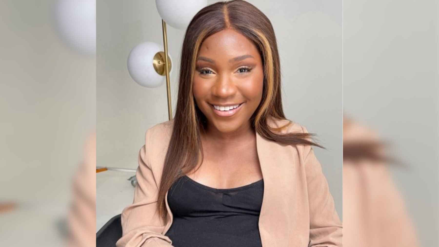 Taylor Lindsay-Noel smiling as an entrepreneur and accessibility advocate in her wheelchair.