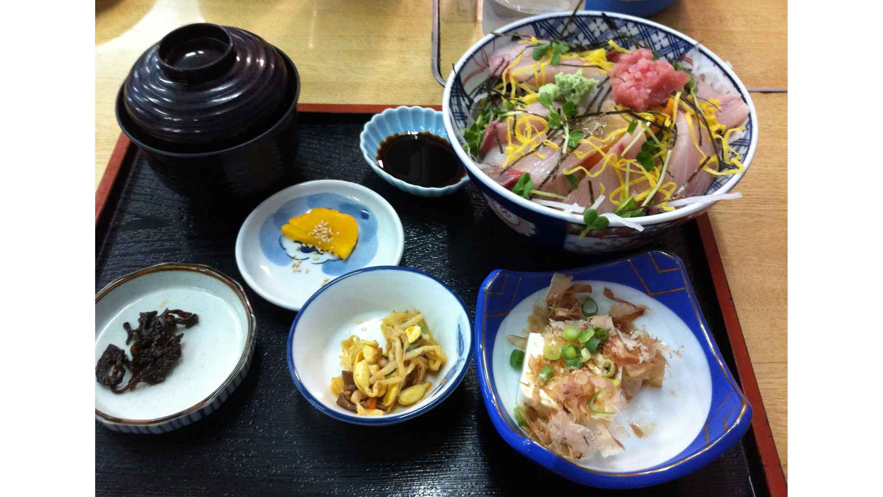 Traditional Japanese washoku meal with raw fish, seaweed, vegetables, soy-based foods, and side dishes