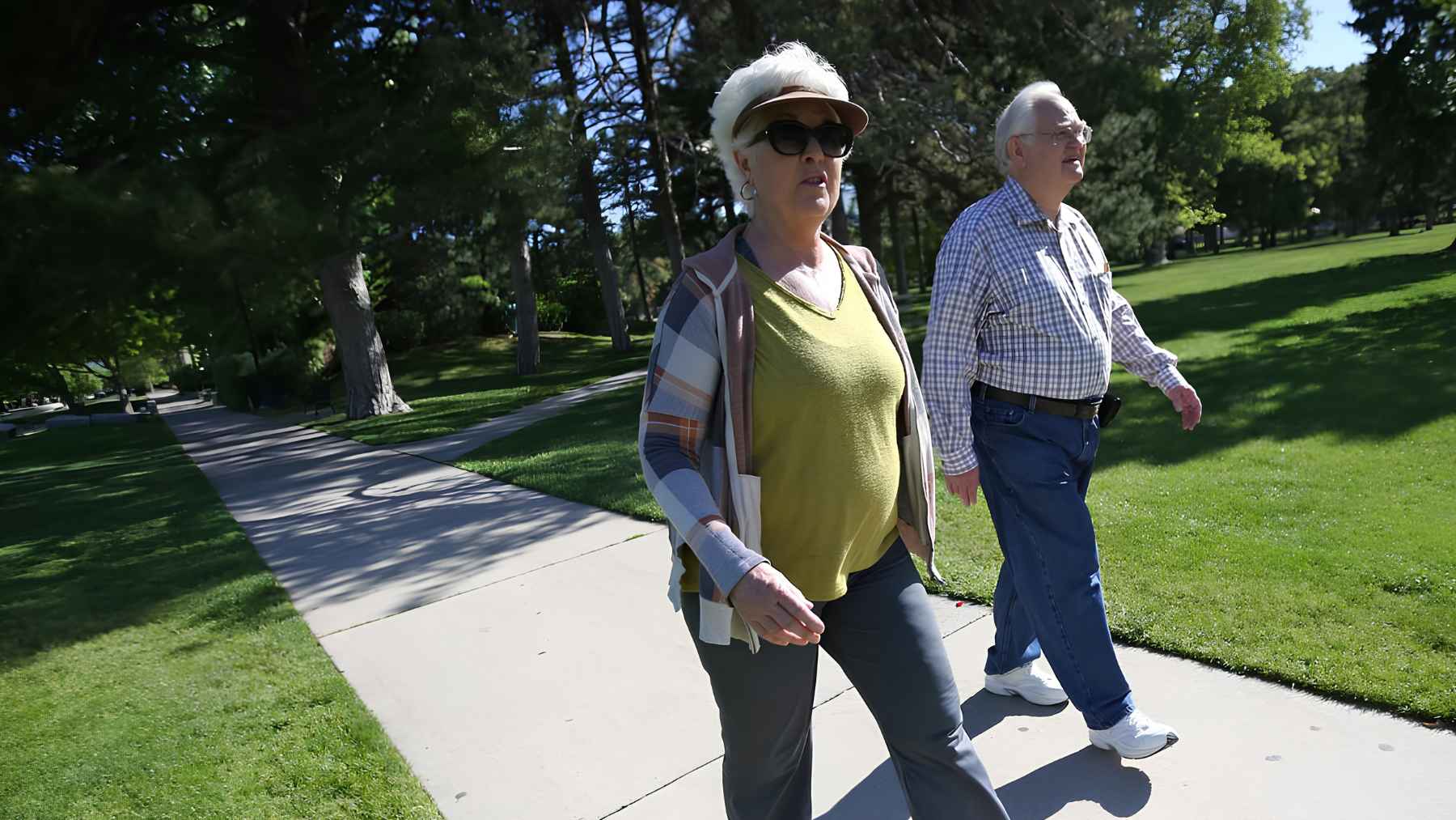 An older adult walking outdoors to improve mobility and manage knee osteoarthritis with low-impact exercise.