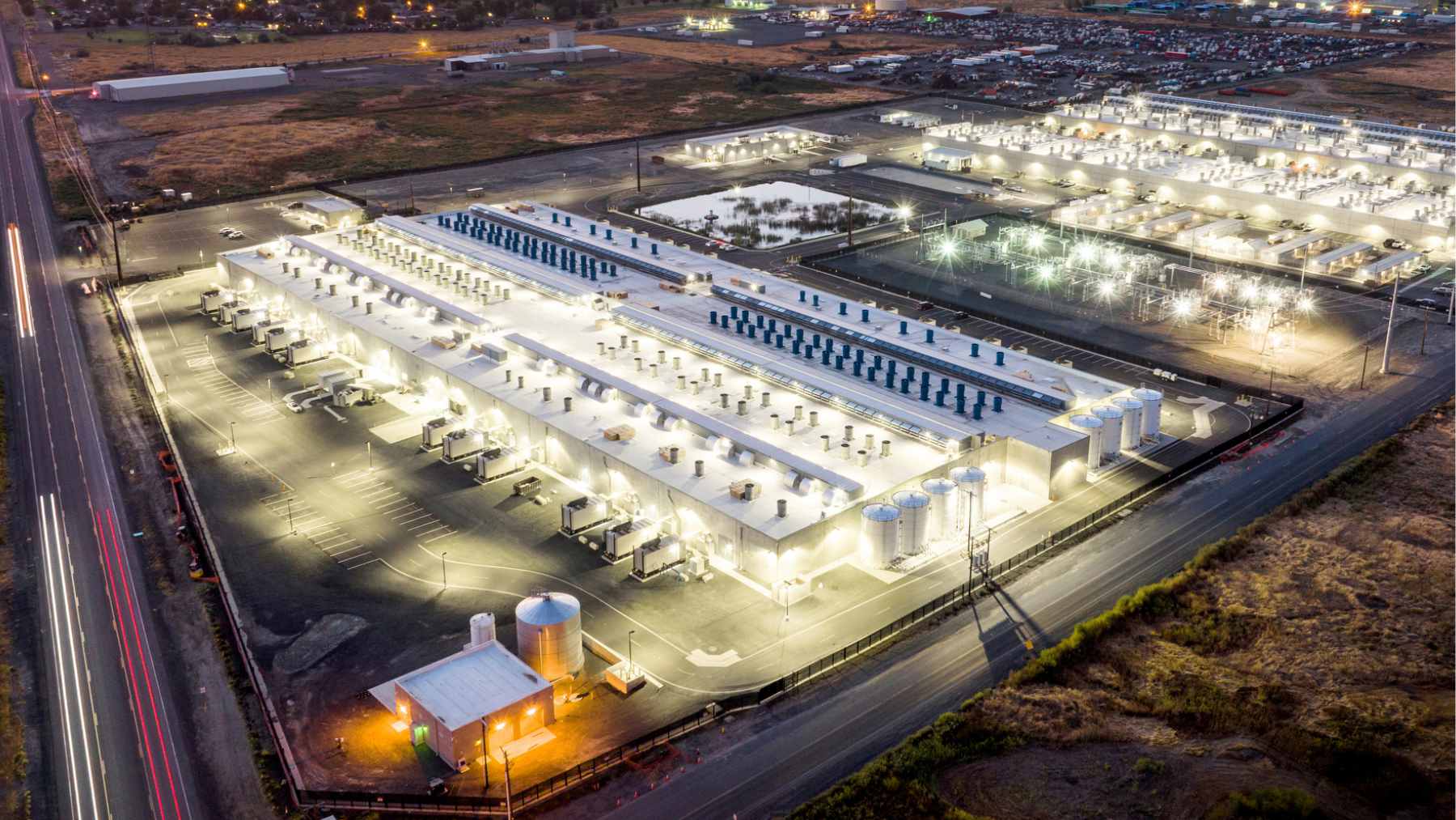 An aerial view of a massive data center complex in rural Morrow County, Oregon, highlighting the physical scale of the cloud infrastructure.