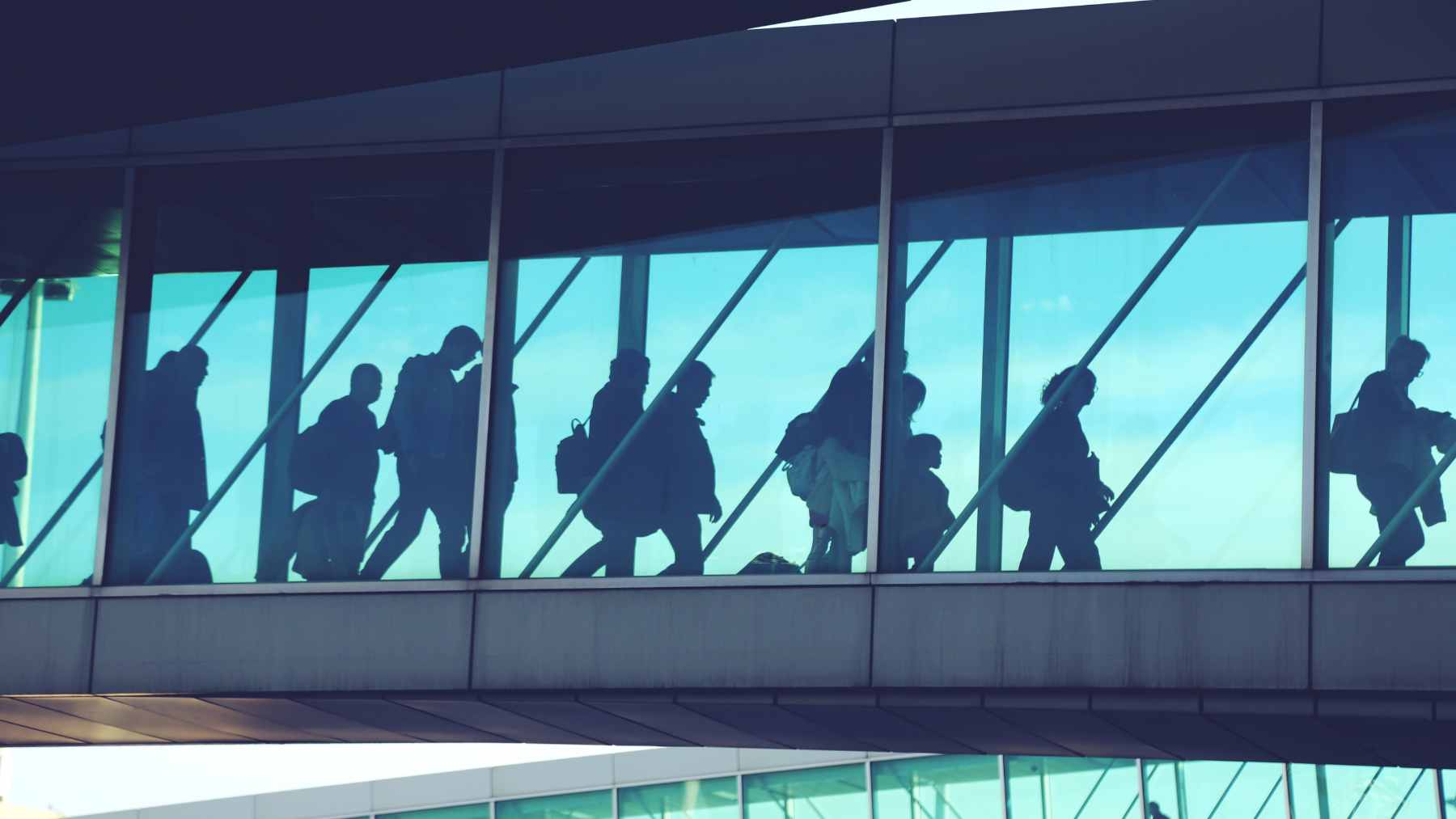 : A crowded TSA security checkpoint at a major U.S. airport during a period of high traveler volume and staffing shortages.