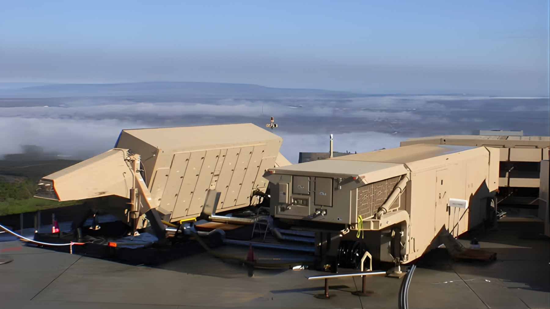 Satellite imagery showing the damaged perimeter of a high-altitude missile defense radar station in the Middle East.