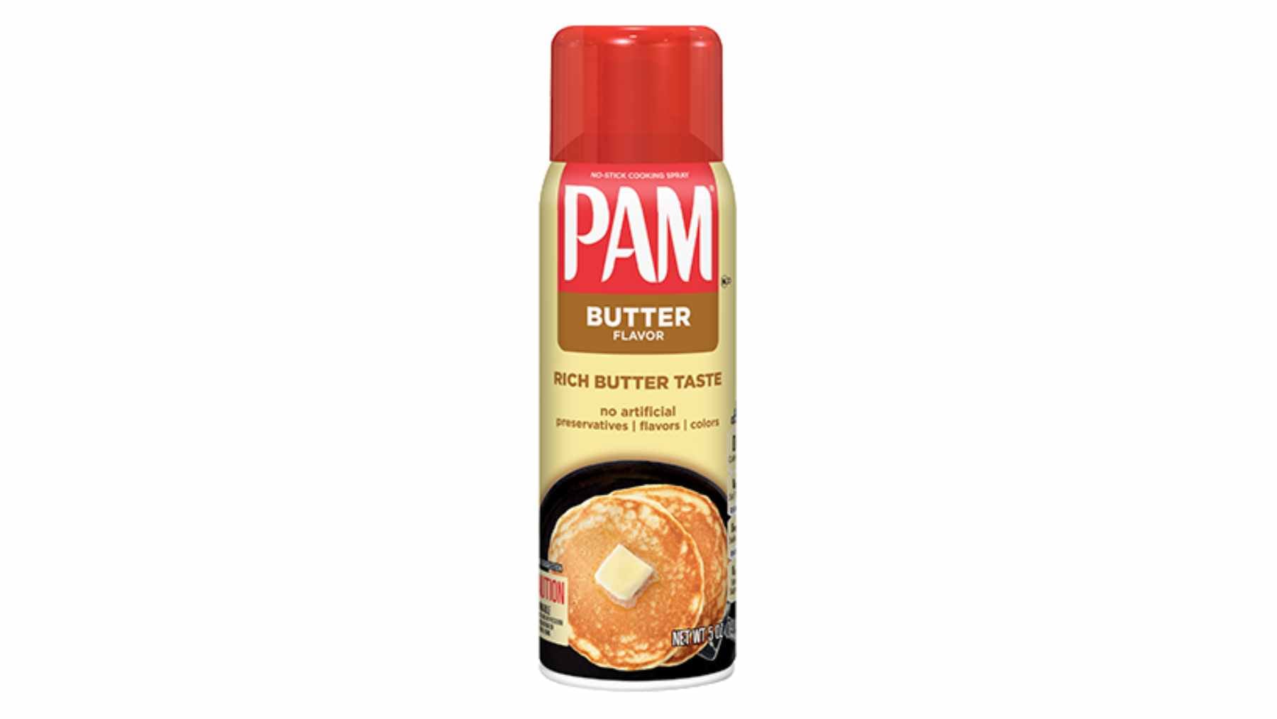 A can of PAM Butter Flavor cooking spray sitting on a kitchen counter next to a frying pan.