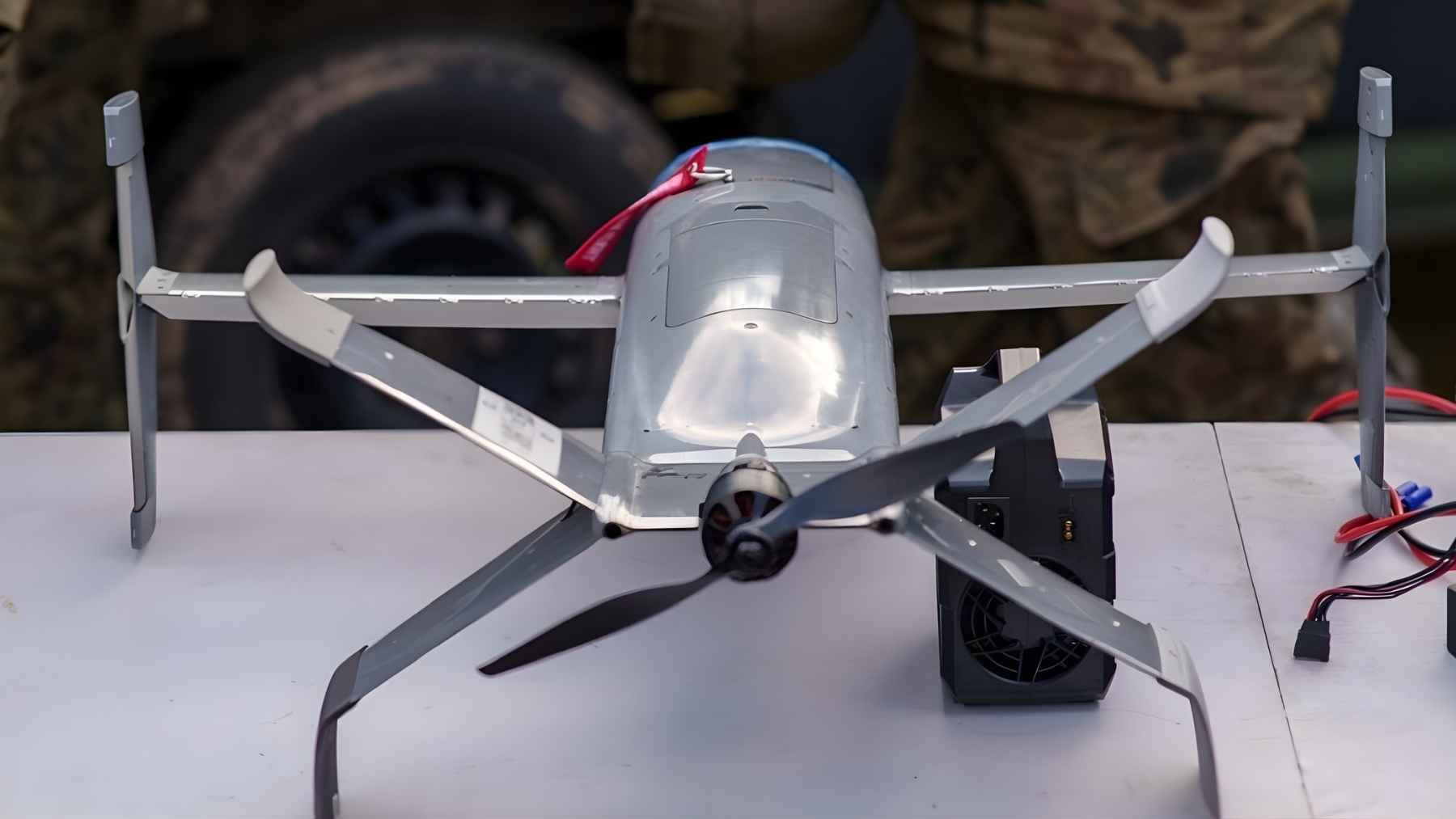 Portable counter-drone aircraft displayed on a table during a military demonstration, illustrating lower-cost air-defense tools gaining attention in Europe