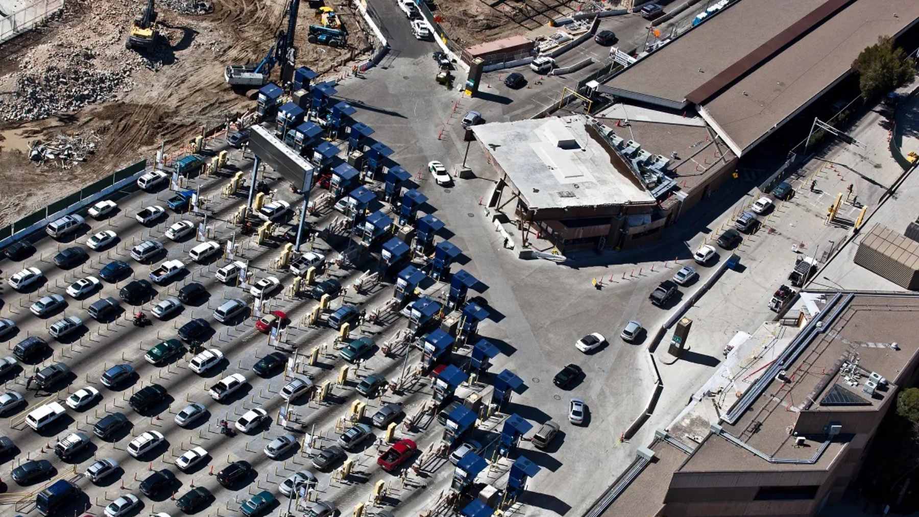 A close-up of a modified vehicle gas tank area showing a non-factory hidden compartment used in a smuggling attempt at the San Ysidro Port of Entry.