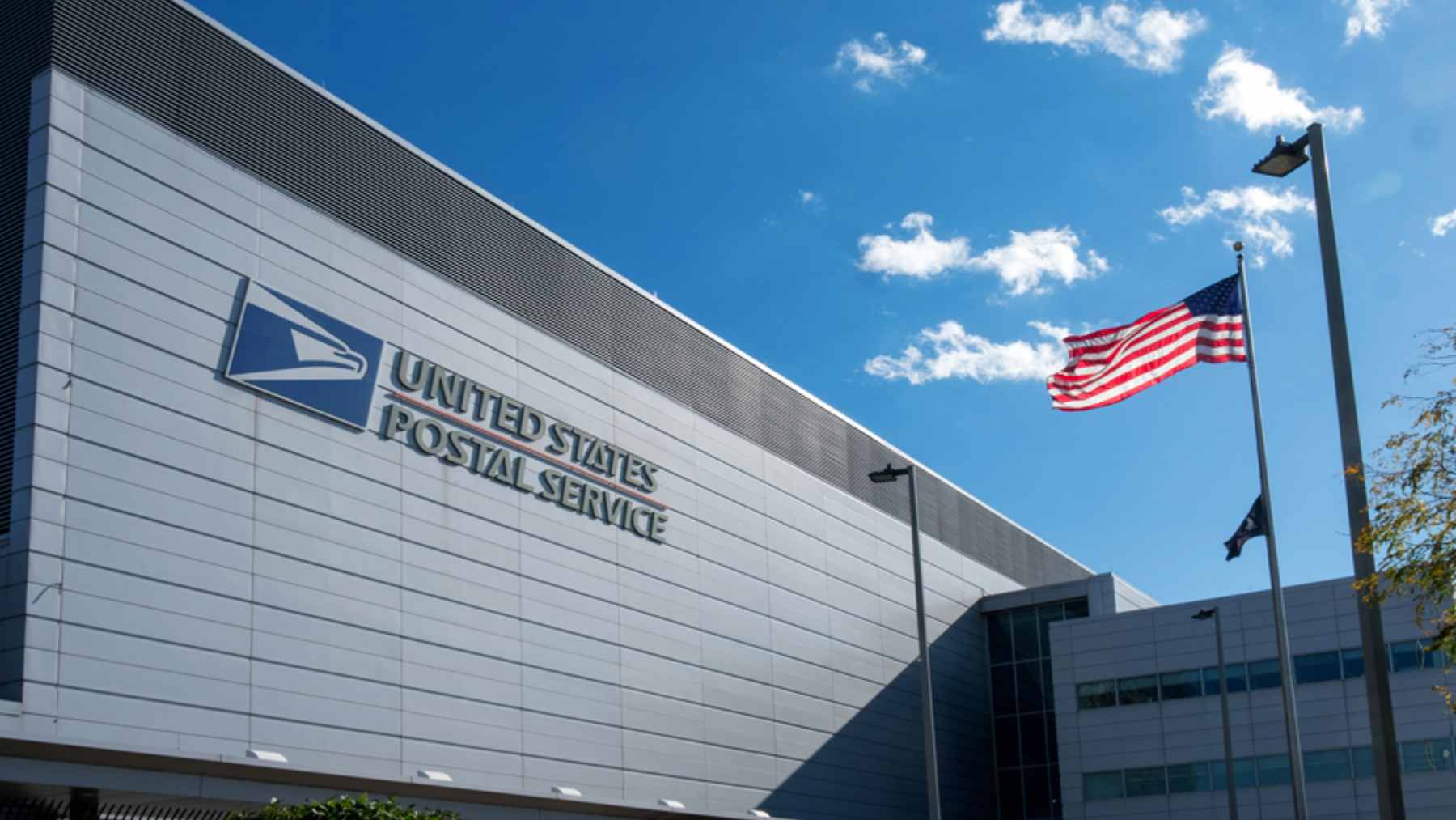 A close-up of a forged bank check sitting next to a monthly financial statement.
