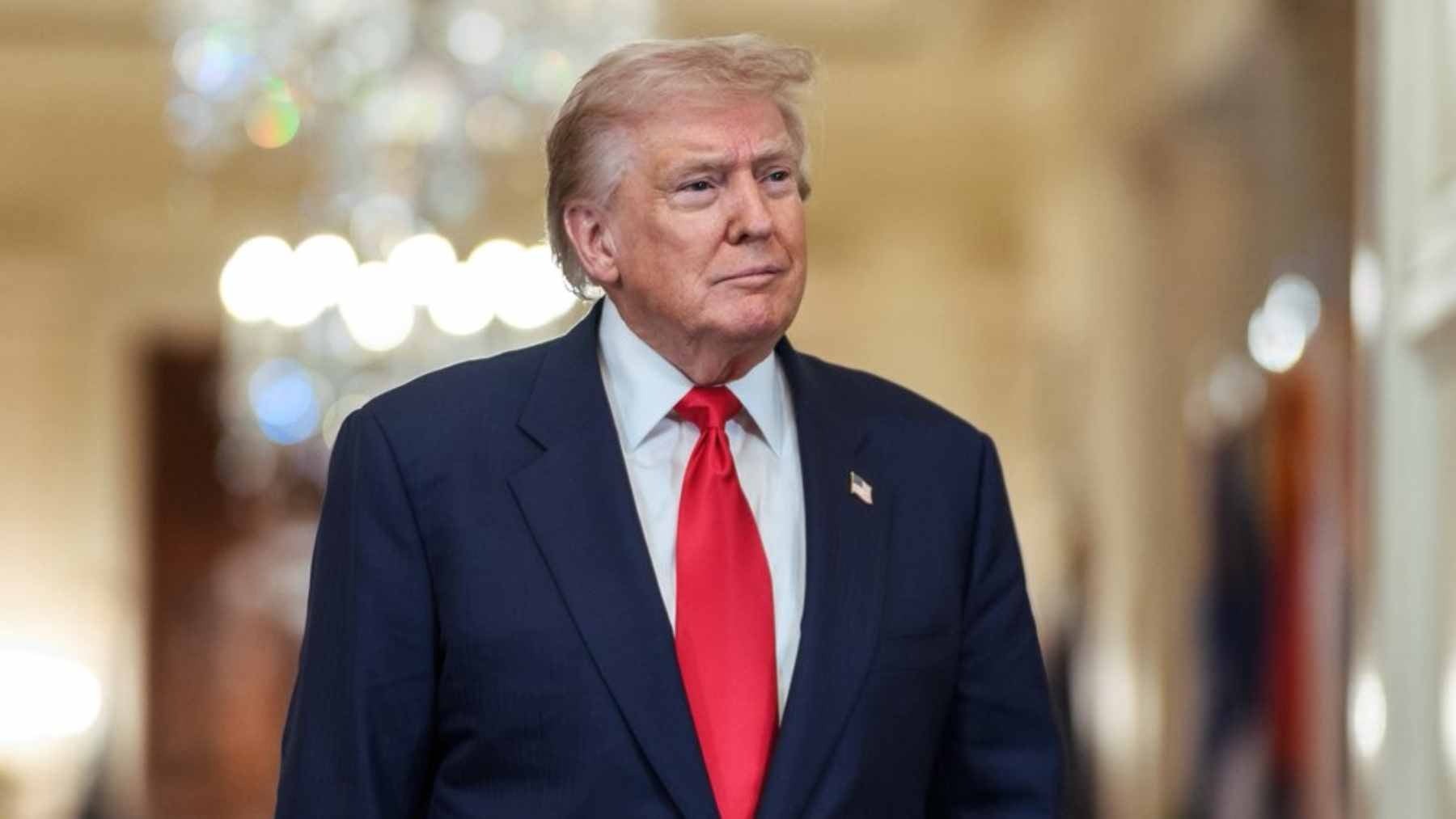 A person at a bank counter presenting a U.S. passport to a teller, illustrating a potential citizenship verification process.