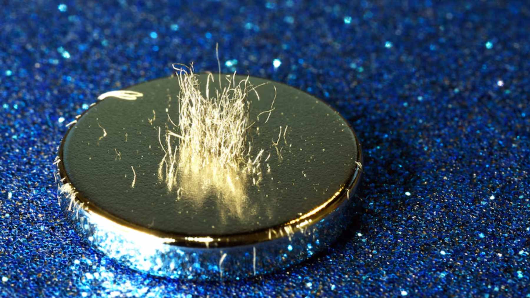 A high-tech laboratory technician inspecting a rare earth magnet used in advanced military radar and missile guidance systems.