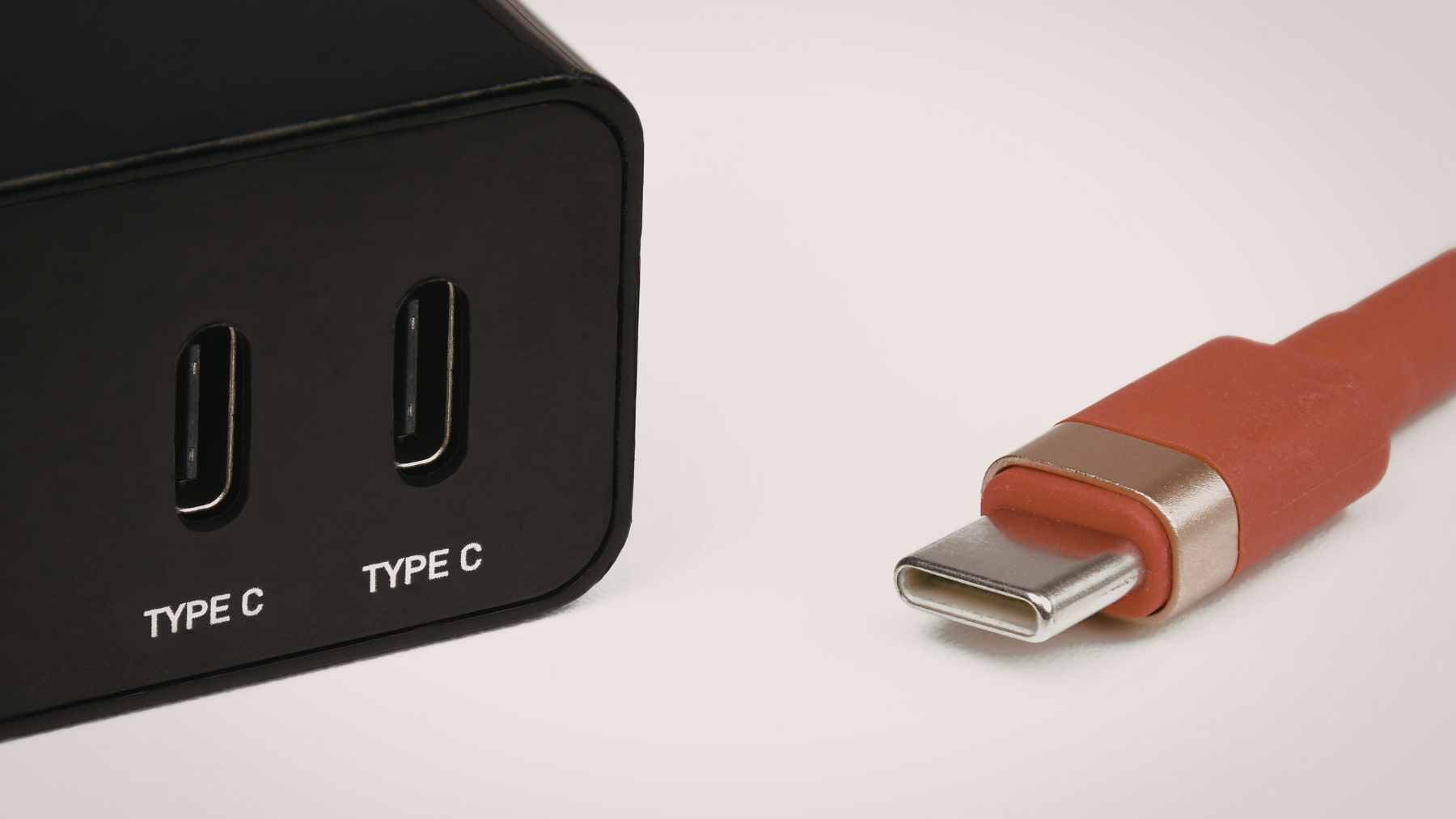 A close-up of a high-quality USB-C connector featuring the official 40Gbps and 240W Power Delivery logos.