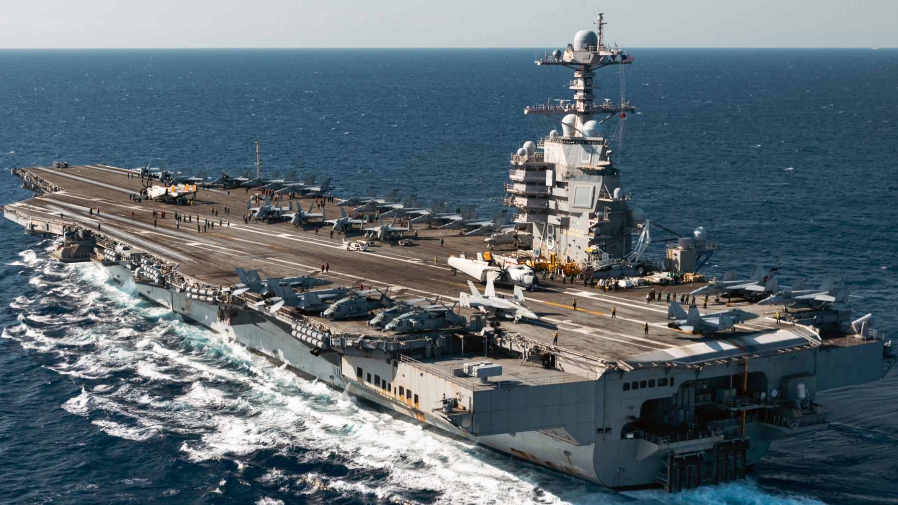 An aerial view of the USS Gerald R. Ford (CVN 78) aircraft carrier navigating the Red Sea during its 2026 deployment.