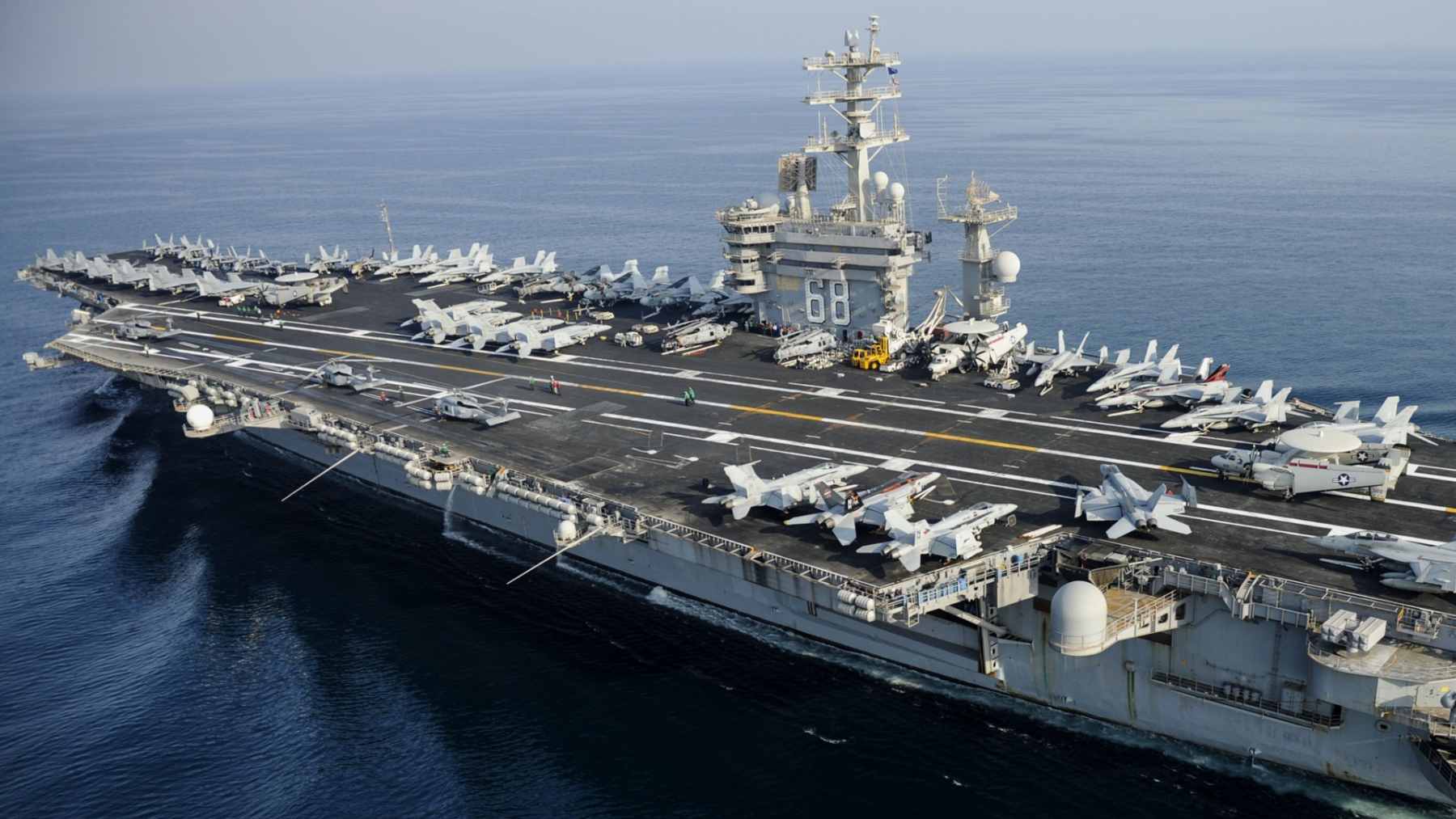 The USS Nimitz aircraft carrier sailing on the open ocean during its final deployment.