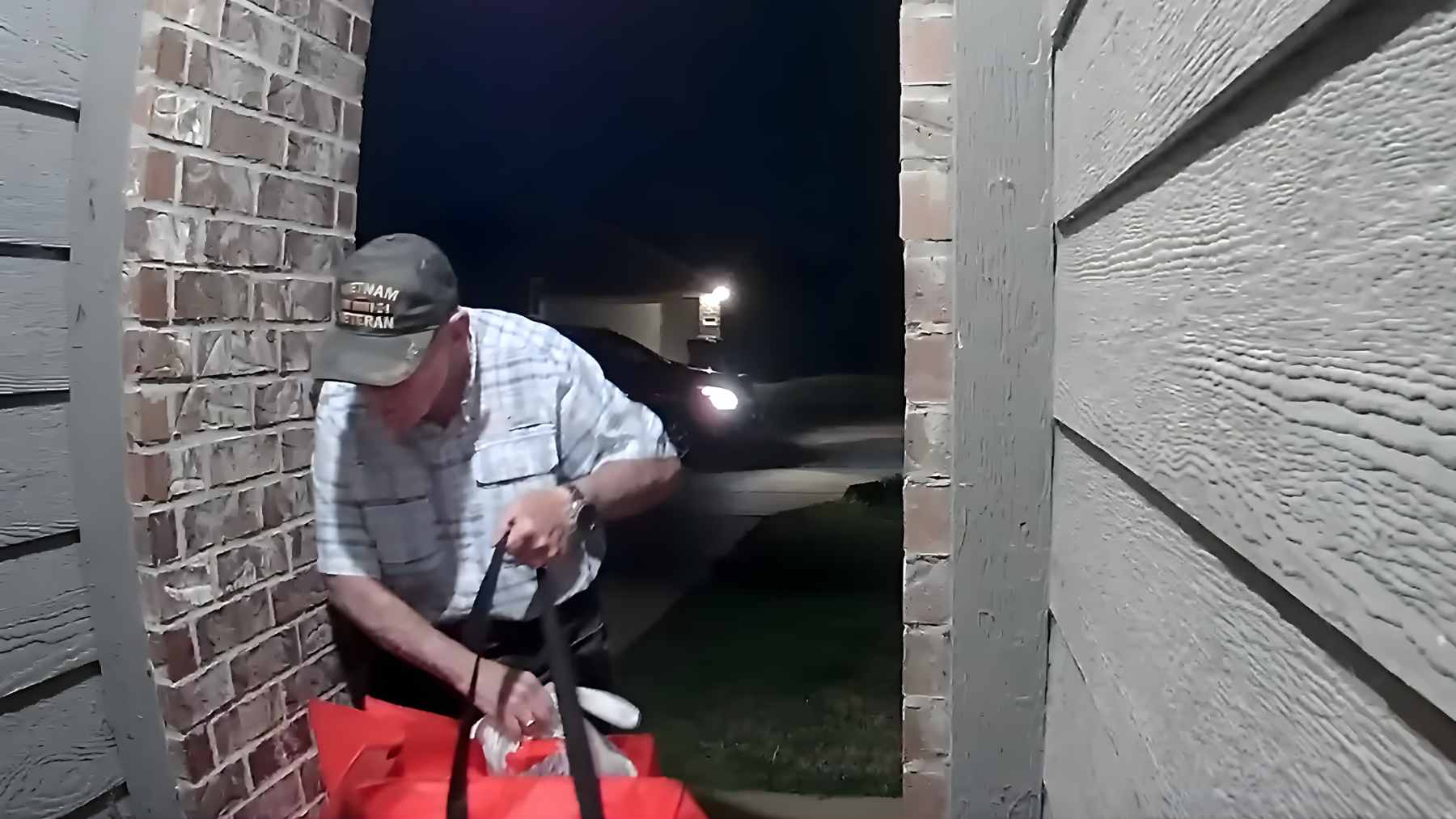 A 76-year-old Vietnam veteran delivering a DoorDash order at night, captured on a residential doorbell camera.
