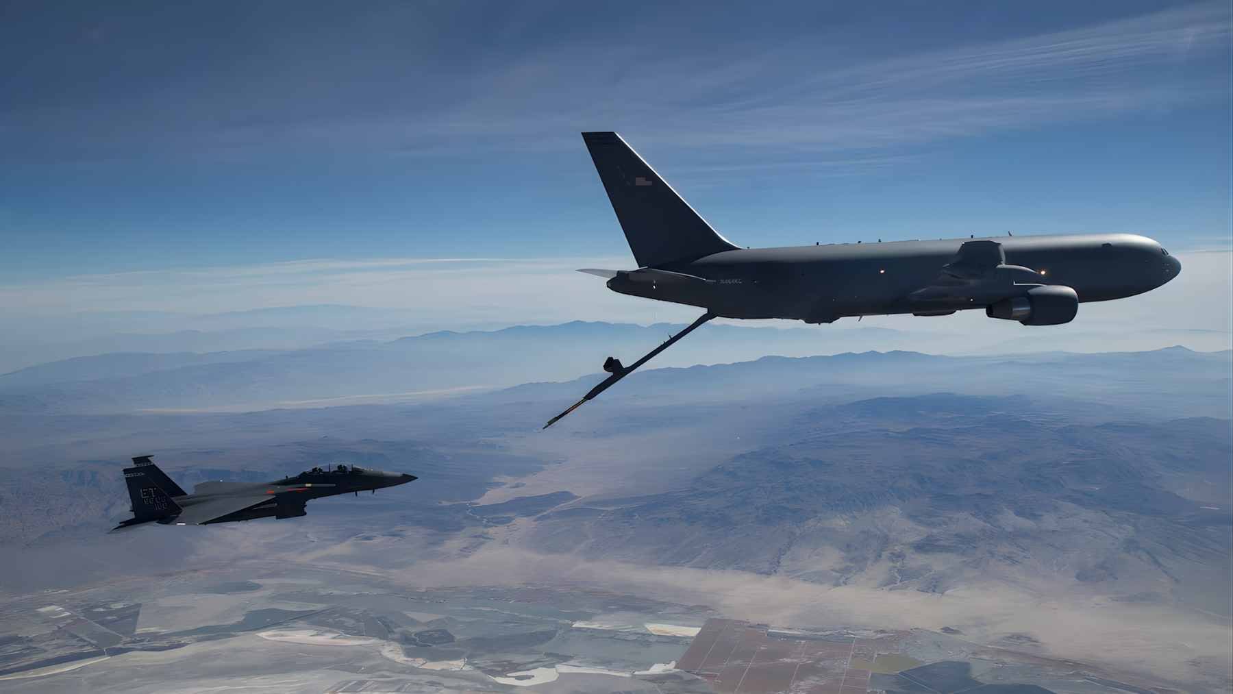 A Boeing KC-46A Pegasus aerial refueling tanker extending its boom toward a receiver aircraft during a restricted test flight.