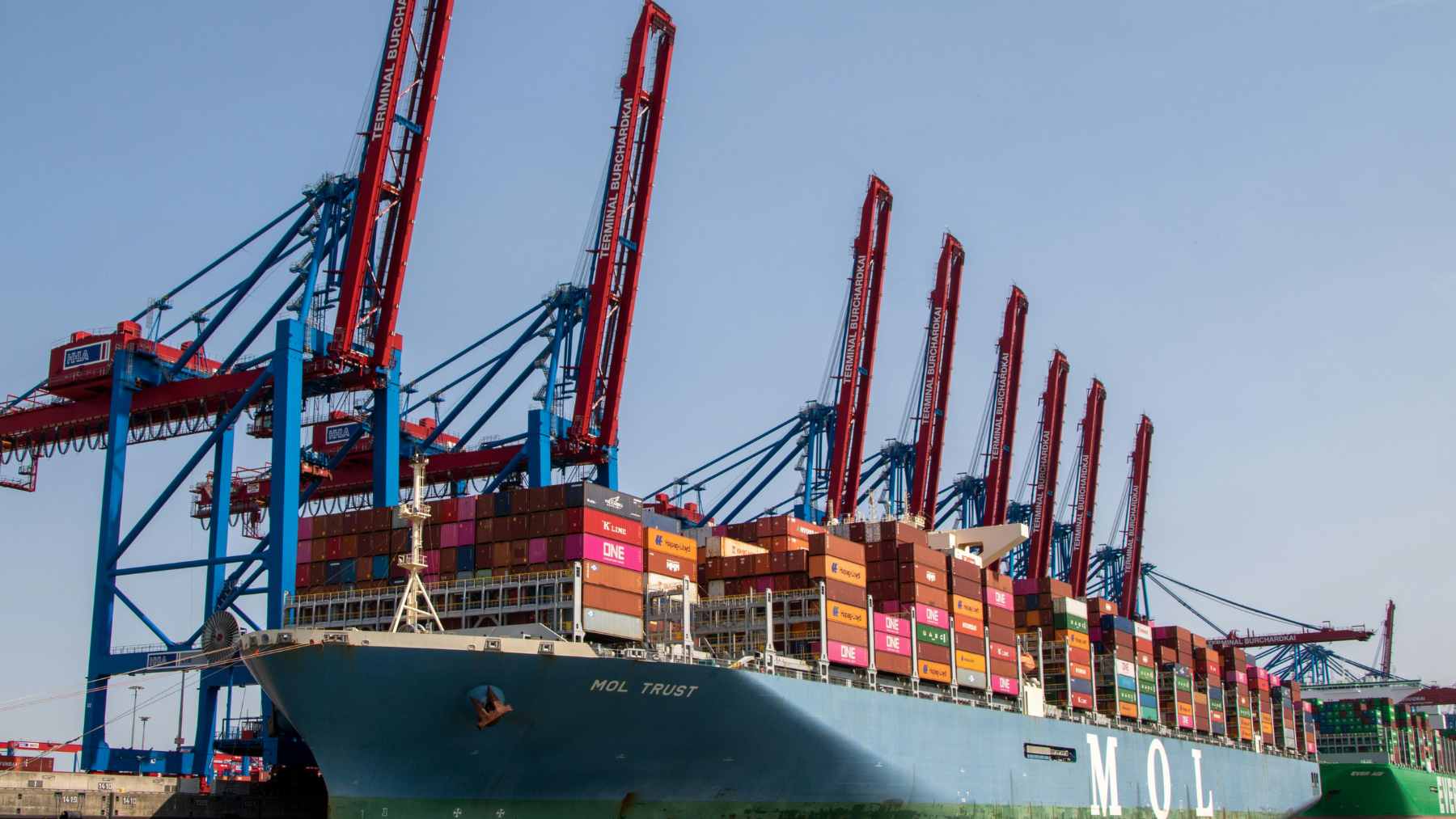 An aerial view of a massive naval and military base facility located on the arid coastline of Djibouti near the Red Sea.