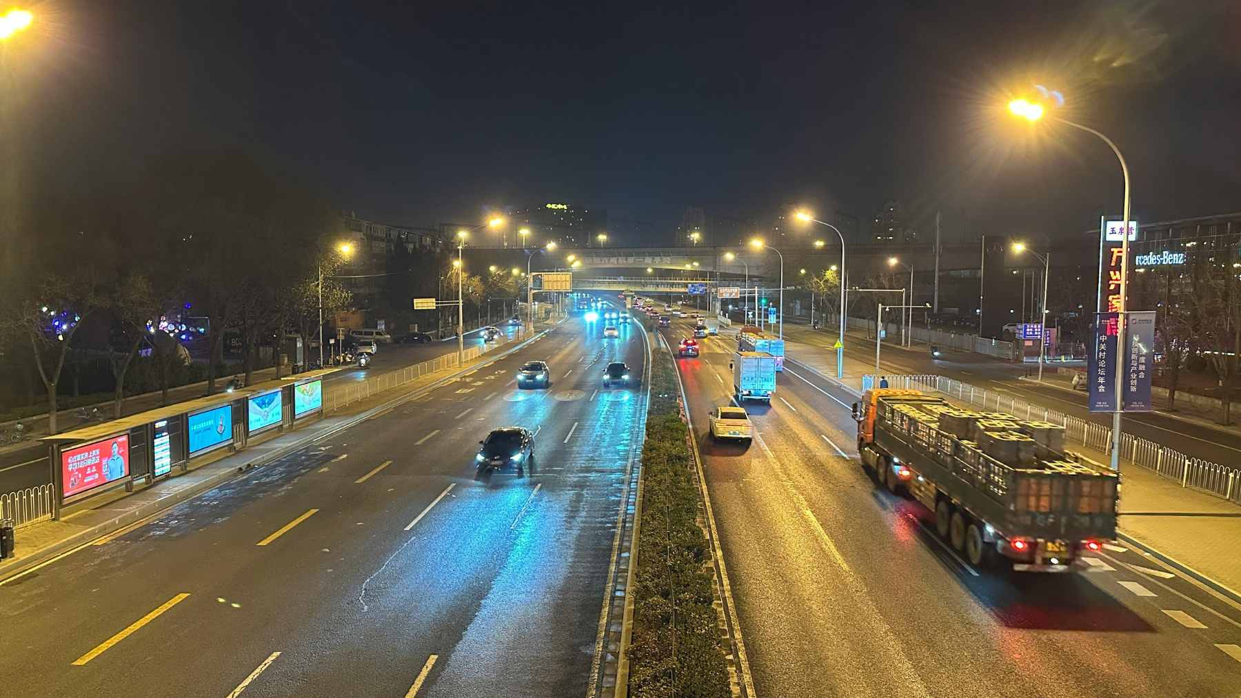 Vibrant green and red laser beams projecting across a dark highway at night to alert drivers.