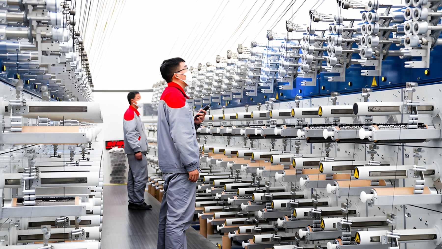 Spools of ultra-high-strength carbon fiber thread being processed in a modern Chinese manufacturing facility.
