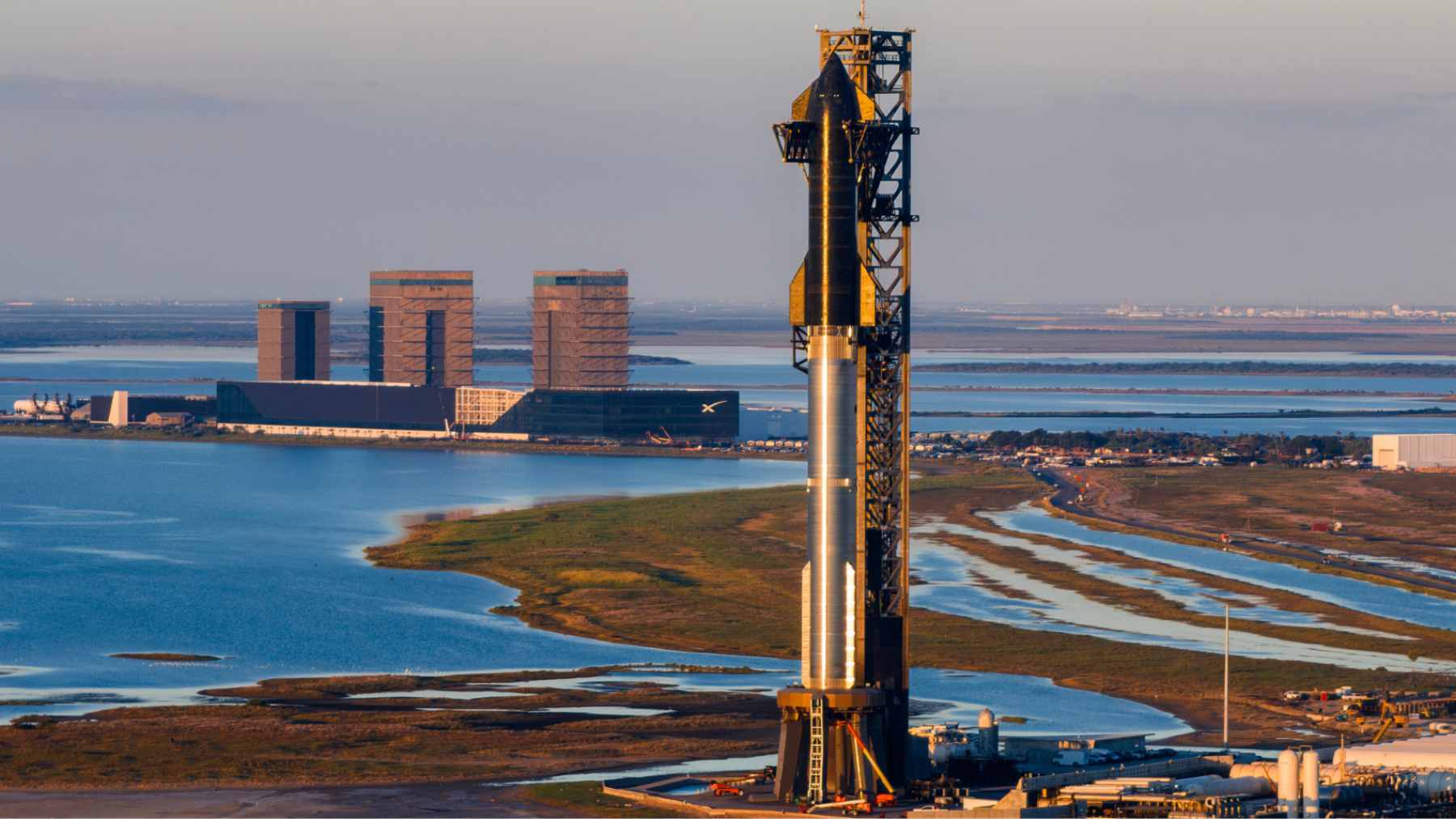 An aerial view of the SpaceX Starbase launch facility in Boca Chica, Texas, sitting directly adjacent to protected coastal wetlands and beaches.