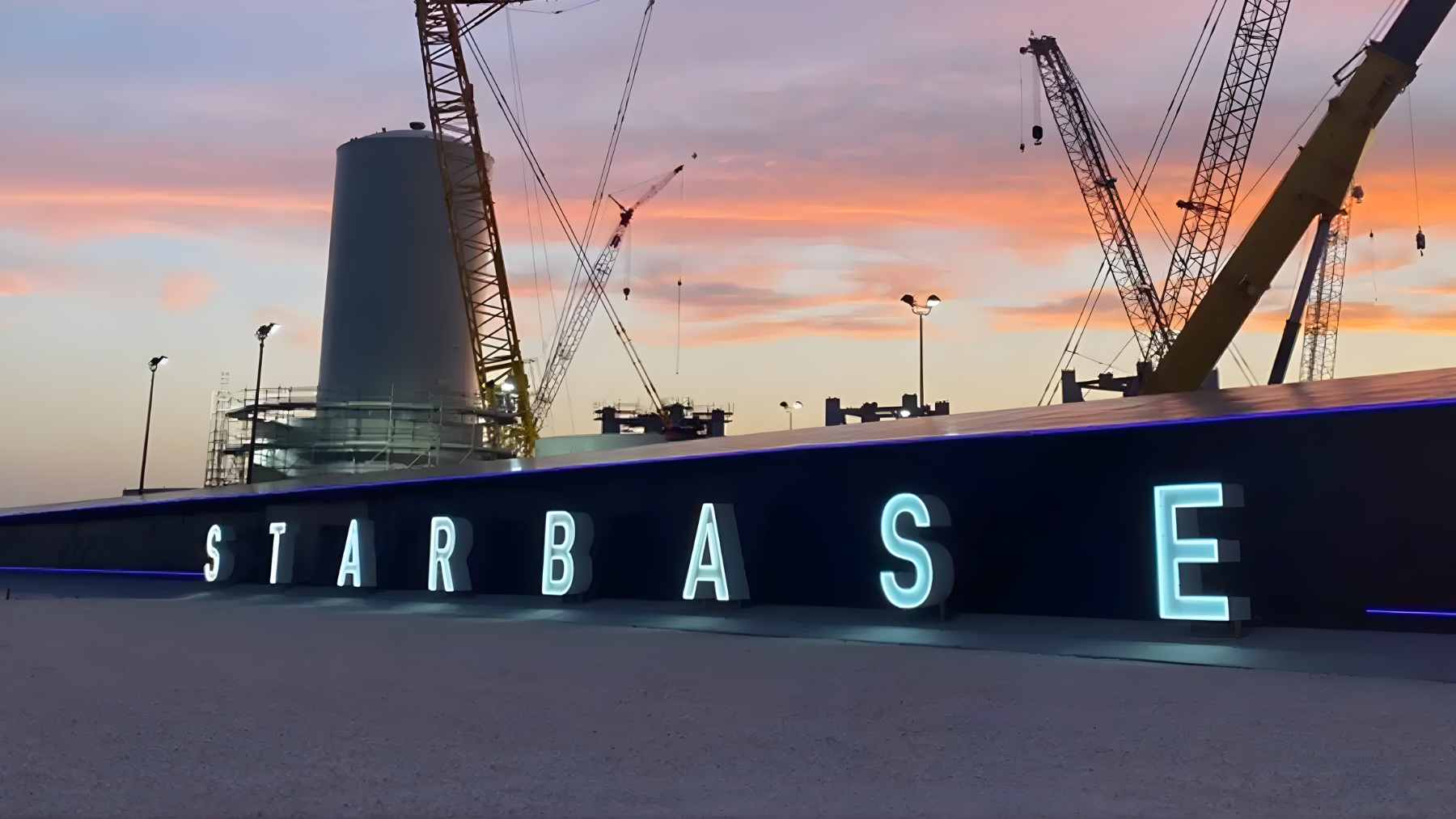 An aerial view of the SpaceX Starbase launch facility in Boca Chica, Texas, sitting directly adjacent to protected coastal wetlands and beaches.