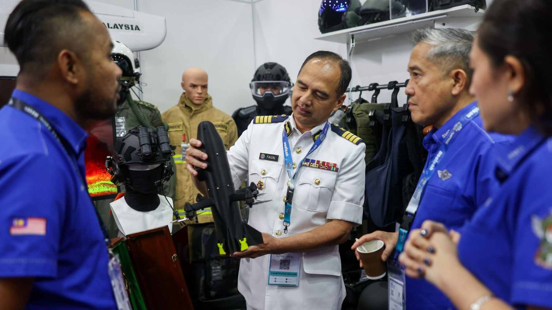 A sleek, lightweight "Ghost" interceptor drone displayed on a stand at a defense technology exhibition.
